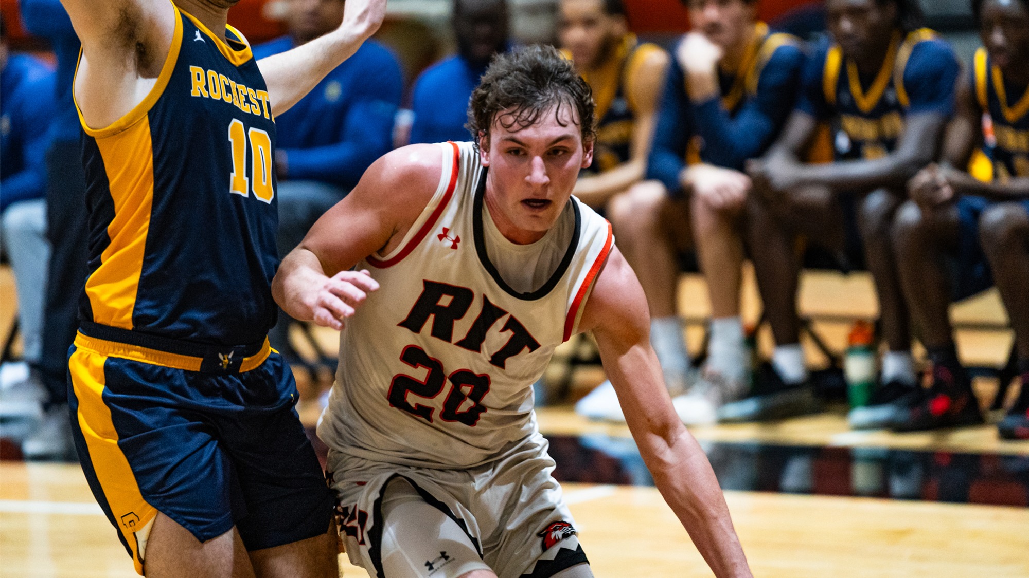A Rochester Institute of Technology men's basketball player drives to the basket in the game against Rochester on Tuesday, January 6, 2025