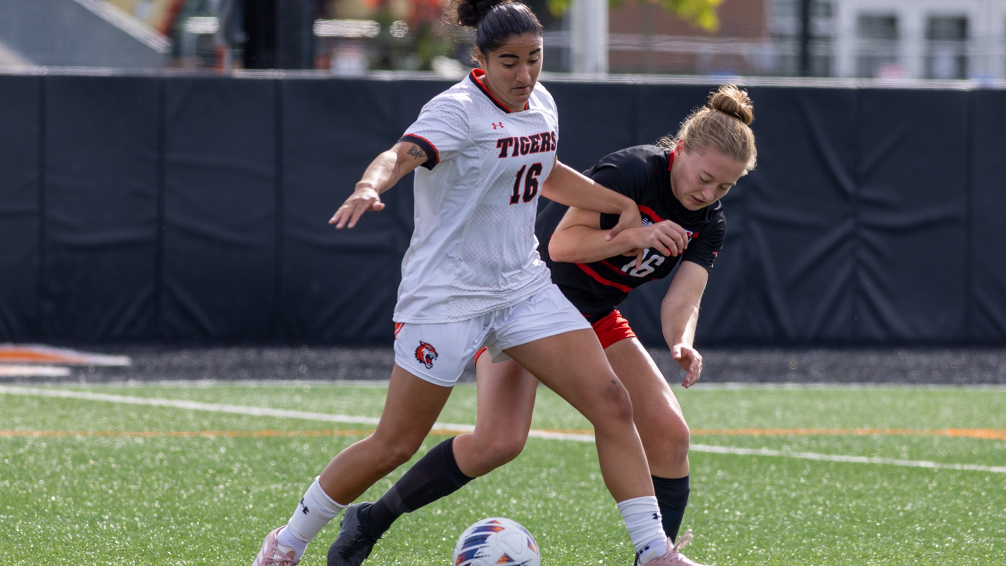 An RIT women's soccer player battles a player from RPI for the ball in a game on September 26, 2026 at Judson Stadium