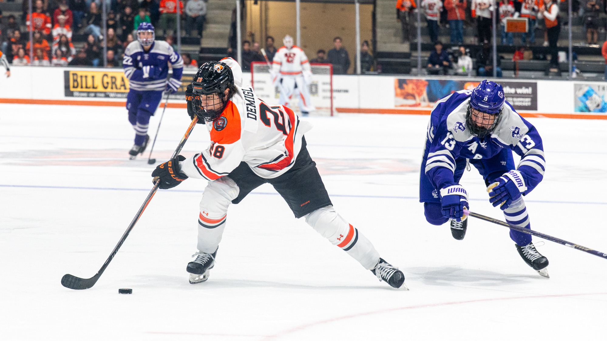 a men's hockey player out-skating a defender