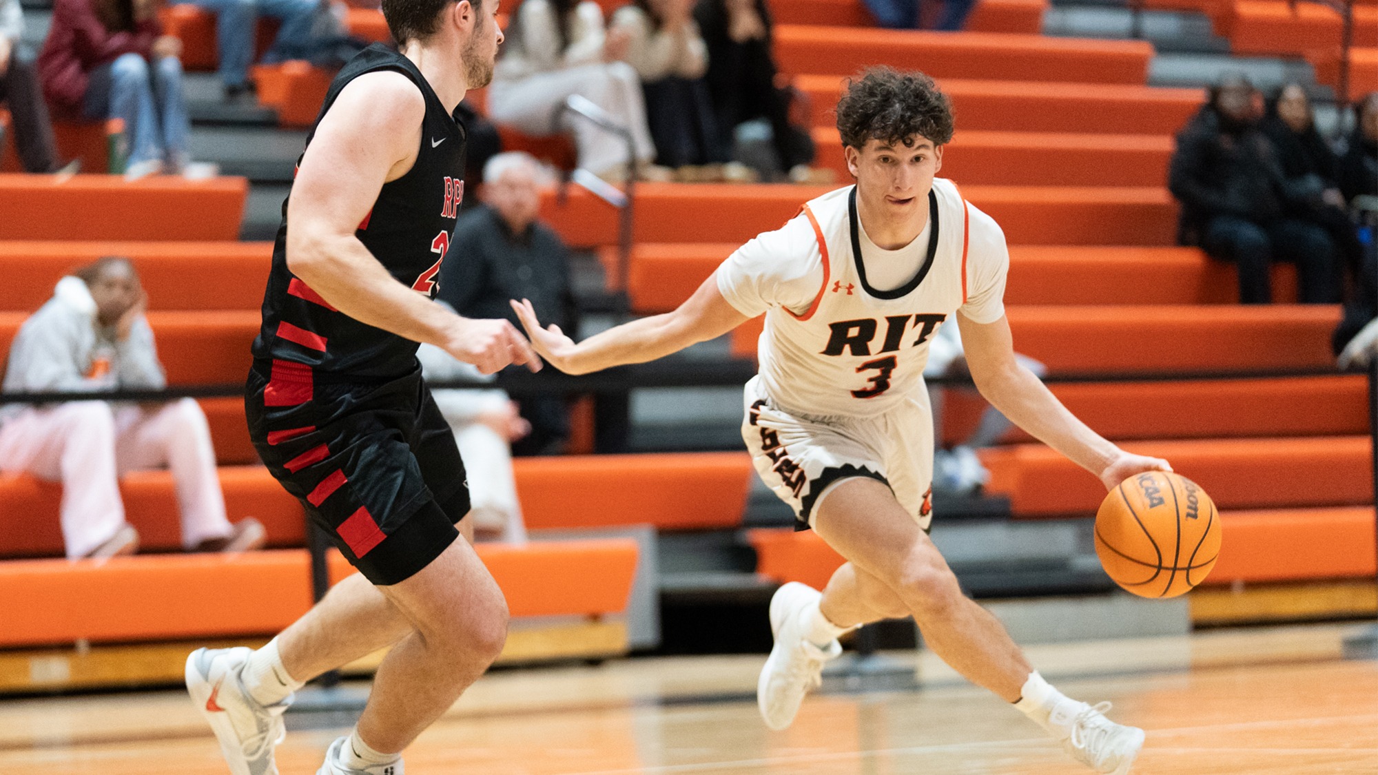 RIT’s Danny Cohen, #3, dribbles the ball past a RPI defender on January 17th, 2026, at the Clark Gymnasium in Henrietta, New York. RIT Men’s Basketball falls to RPI 62-79. 