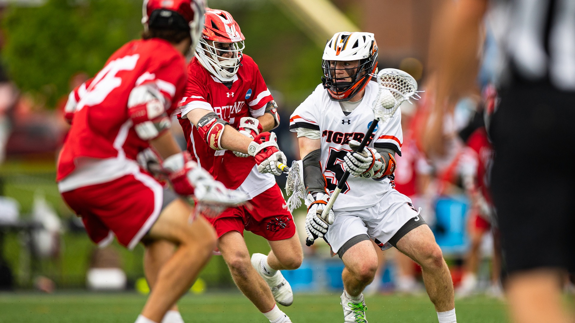 RIT's Ryan Bullock, #5, pushes through opposing players with the ball in game vs Cortland on Saturday, May 17, 2025, at Tiger Stadium. RIT Men's Lacrosse game vs. Cortland. (Mikaela Engstrom/RIT Sports Network).