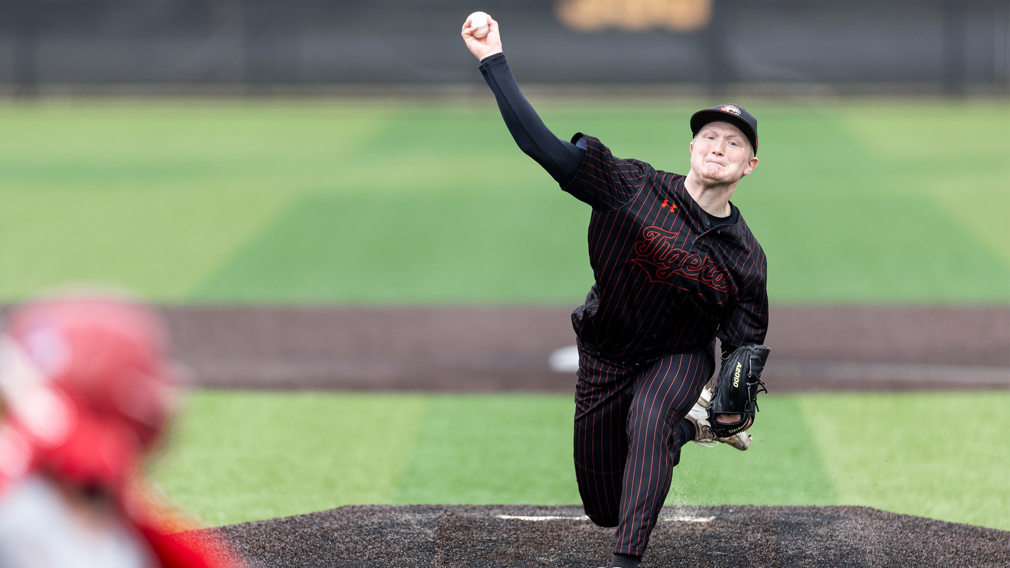 RIT's Ryan Moran, #21, throws a pitch on Friday, March 28, 2025 at RIT Baseball Complex in Henrietta, N.Y. The RIT baseball team defeated St. Lawrence University 7-6.