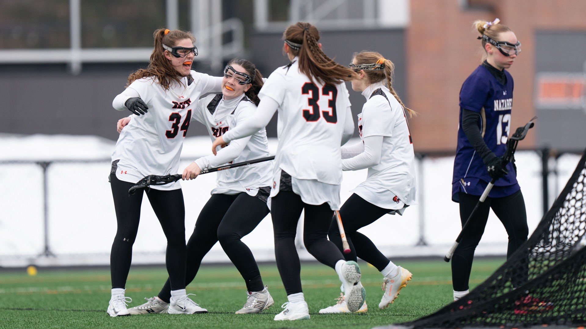 Members of the RIT Women’s Lacrosse team celebrate a goal on February 25th, 2026, at Thomas Fearey Judson Jr. Stadium in Henrietta, New York. RIT Women’s Lacrosse defeated Nazareth University 16-3. (Colin Norland/RIT Sports Network).