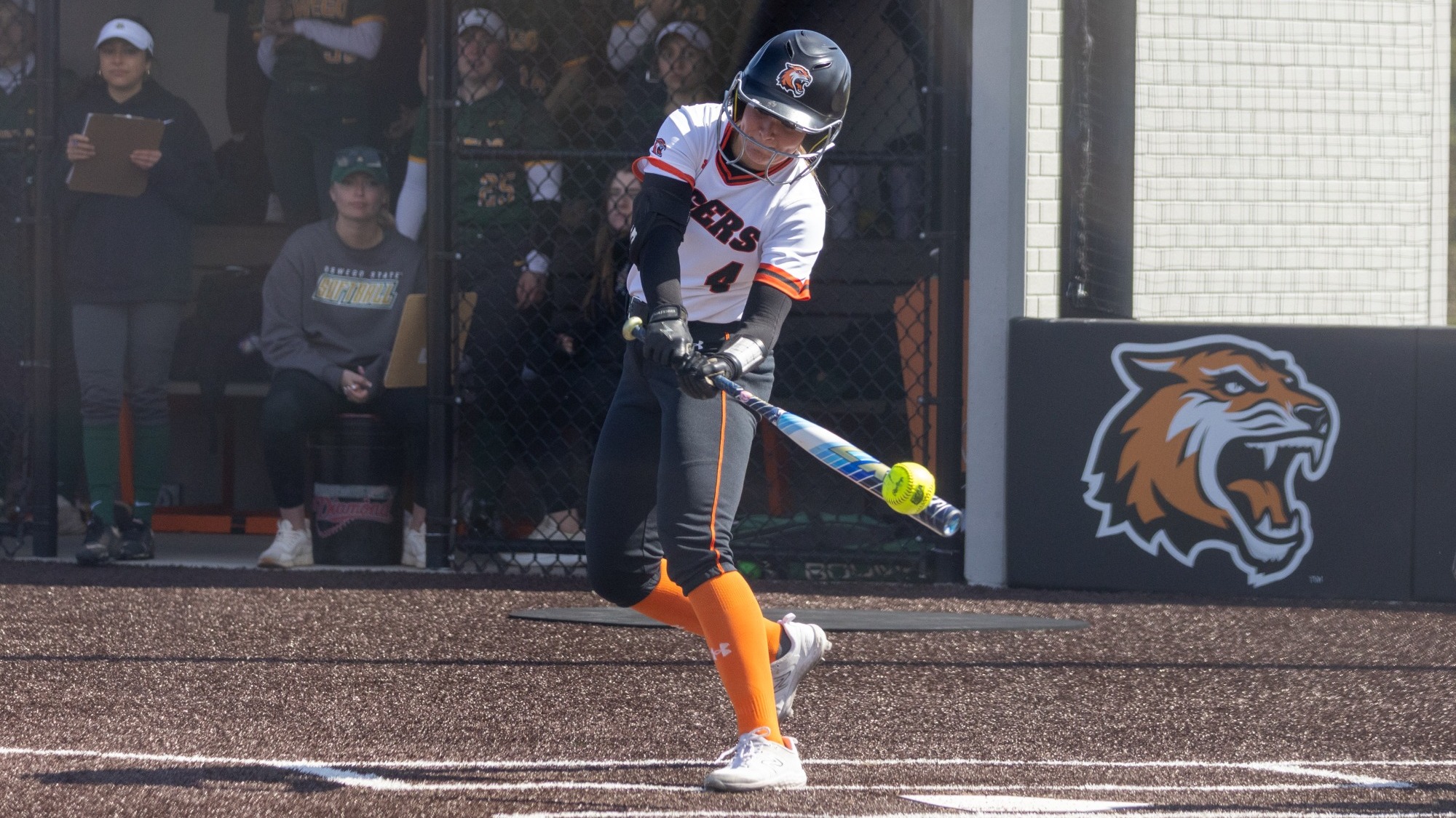 a softball player hitting a ball