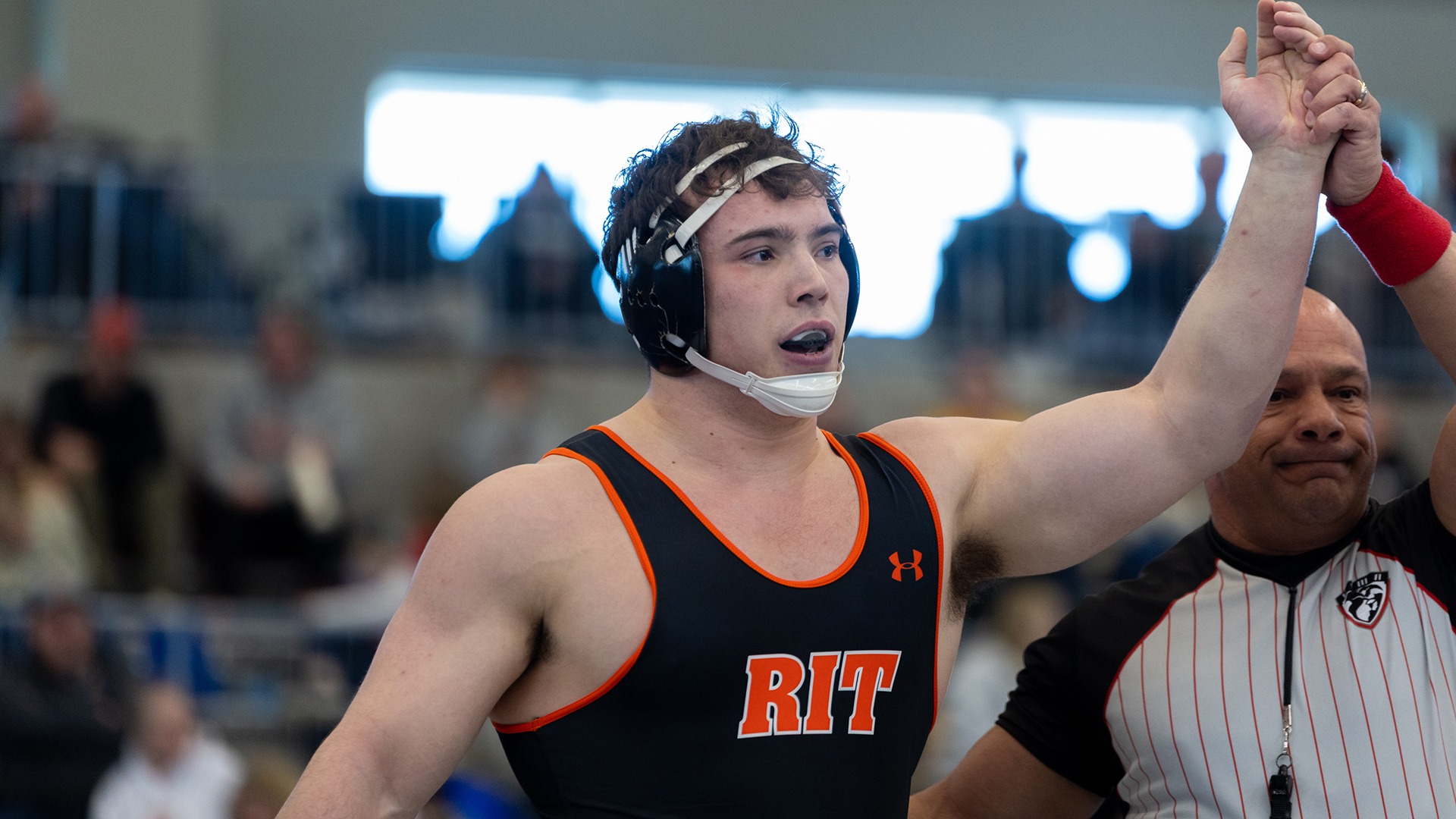 Josh Harkless waving his hand in victory after a match