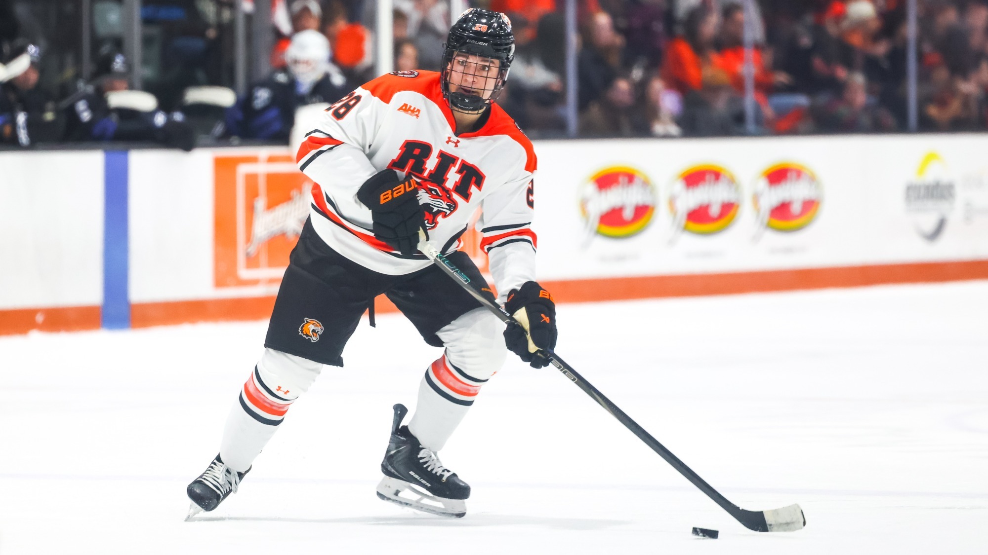a men's hockey player set to pass the puck