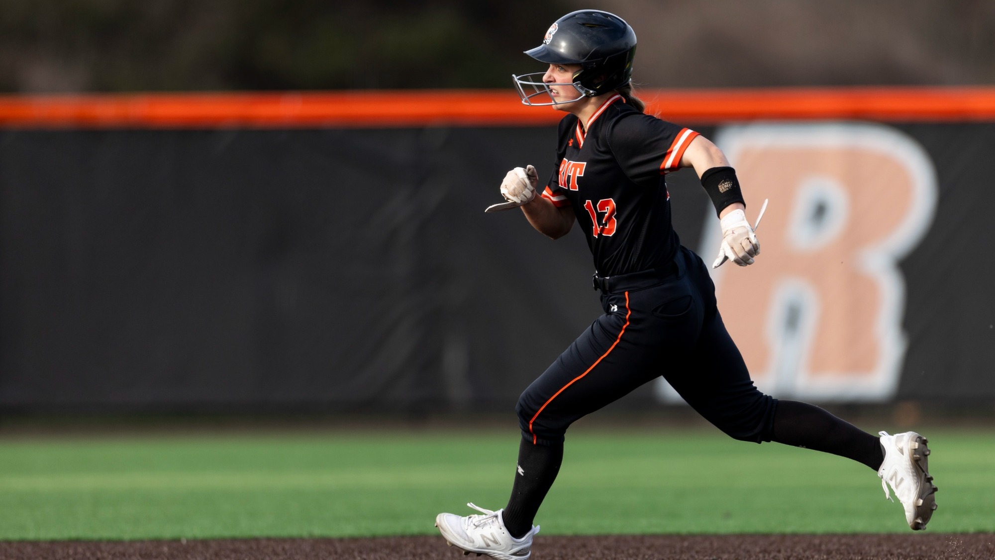 a softball player running between the bases