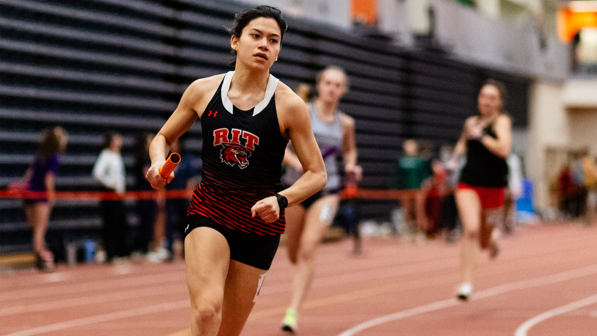 RIT Track and Field athlete runs by in relay on Jan. 24, 2026, at Gordon Field House in Rochester, N.Y. RIT’s Track and Field competes at RIT Friday Invitational. RIT Men’s and Women’s Track and Field. (Sawyer Emery/RIT Sports Network).