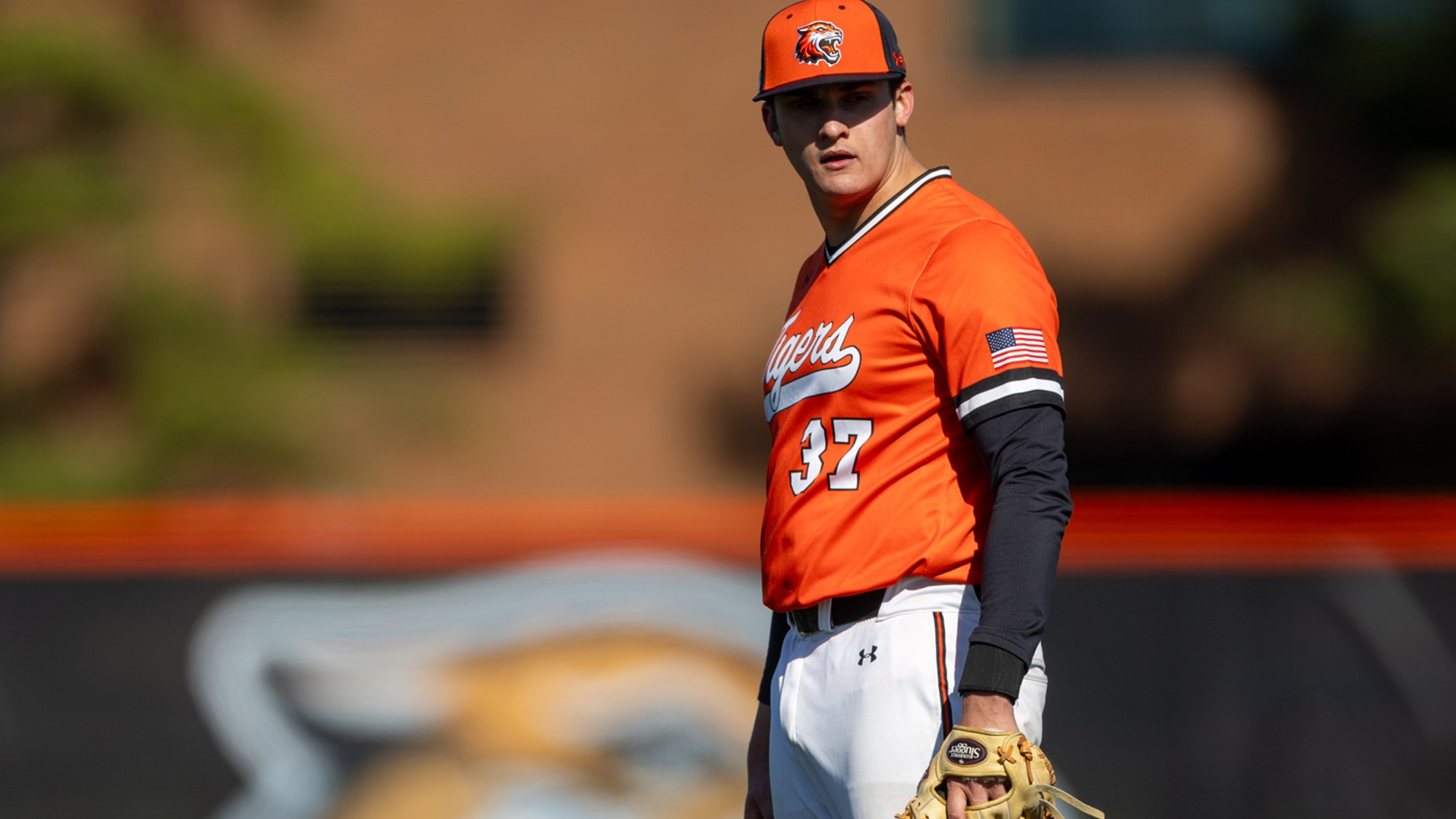 A pitcher for Rochester Institute of Technology decides on a pitch in a game against Alfred State on April 1, 2025