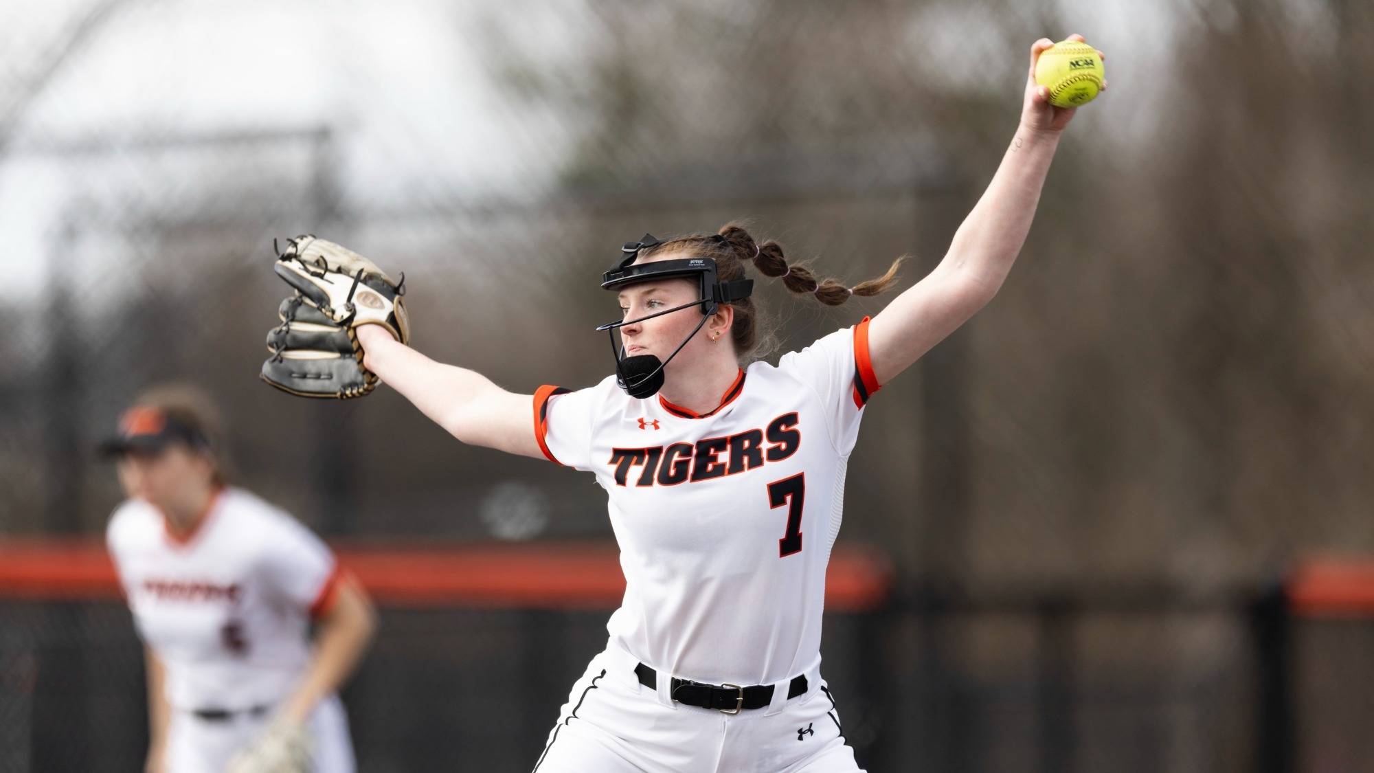 a softball pitcher throwing a pitch