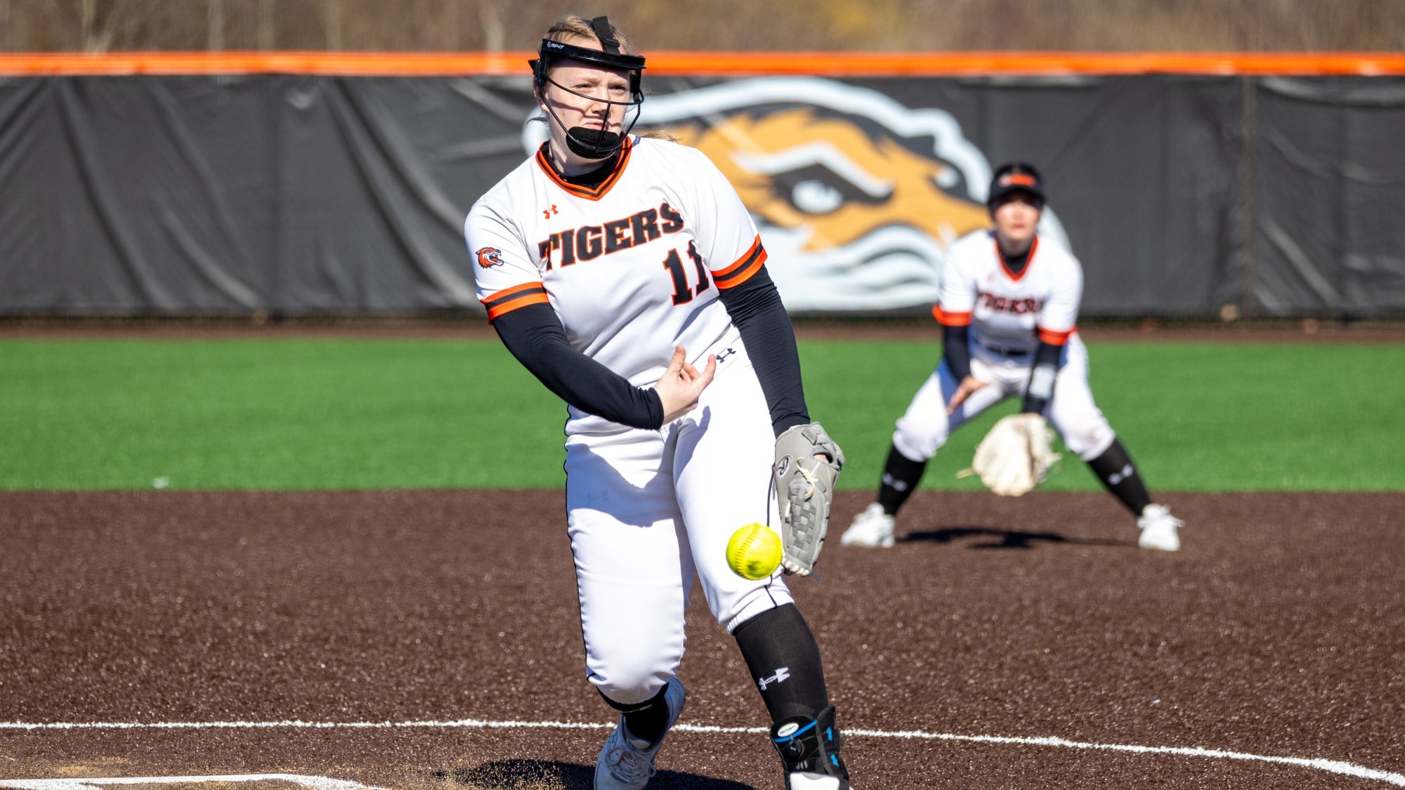 a softball pitcher throwing a pitch