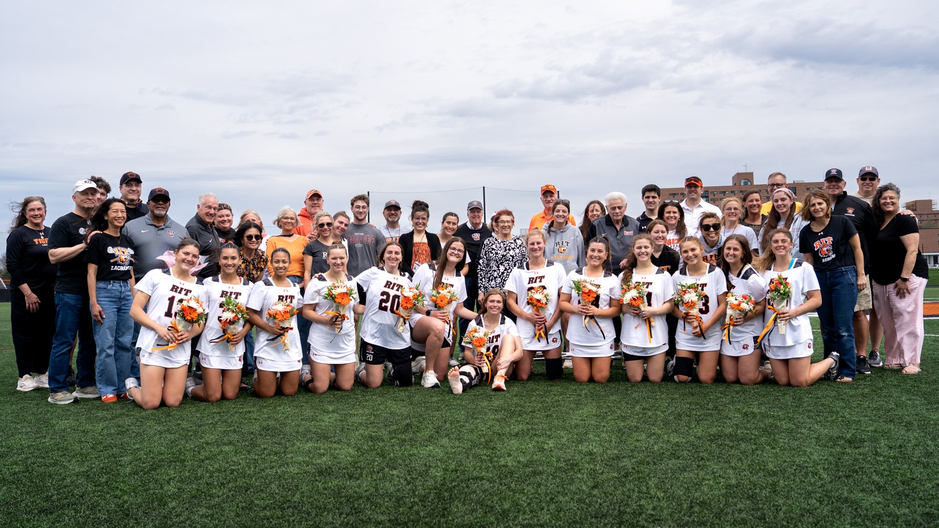 The women's lacrosse seniors pose with family members