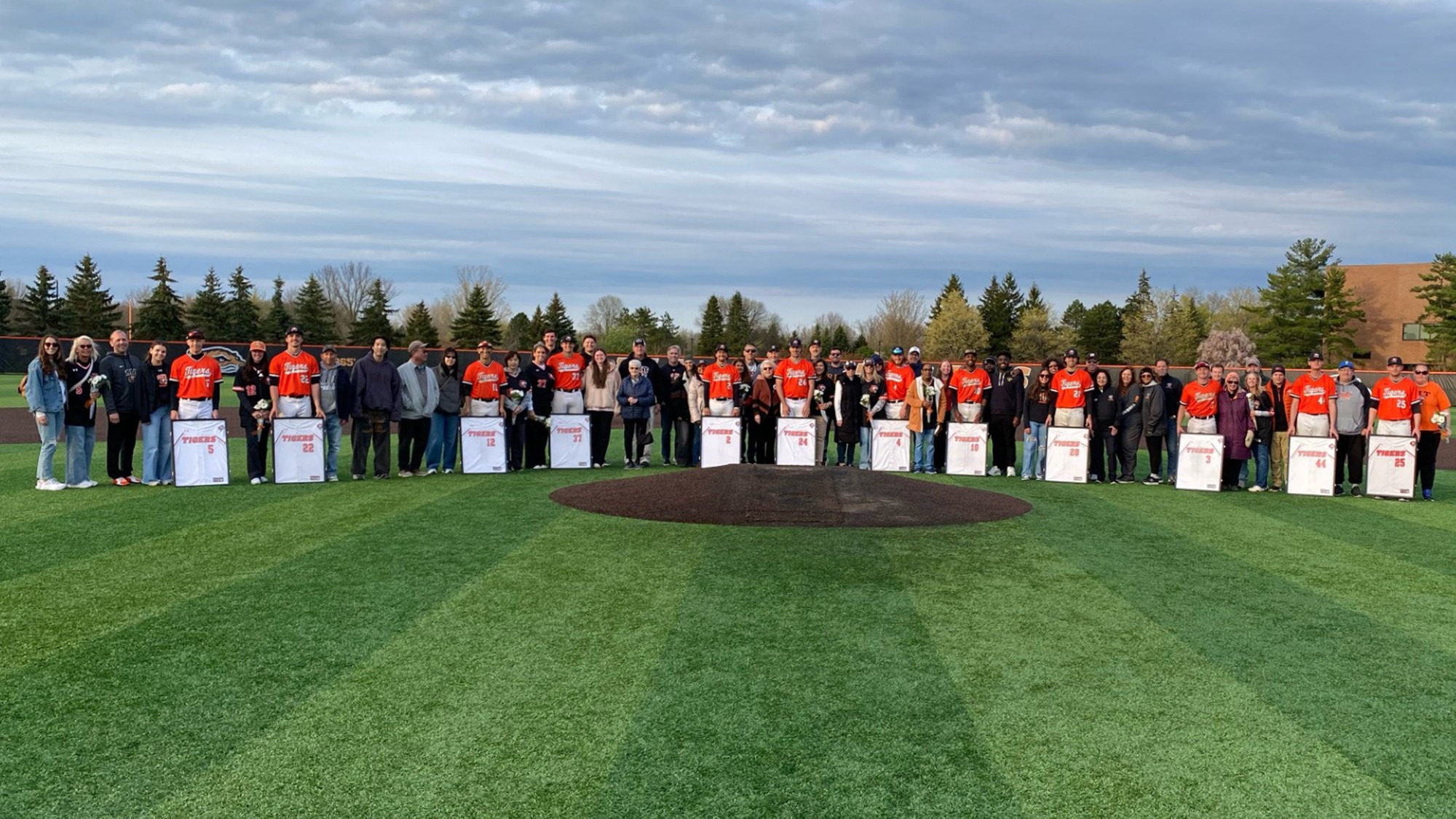 The RIT baseball senior class of 2026 standings with family in a post-game ceremony on Friday, April 24, 2026