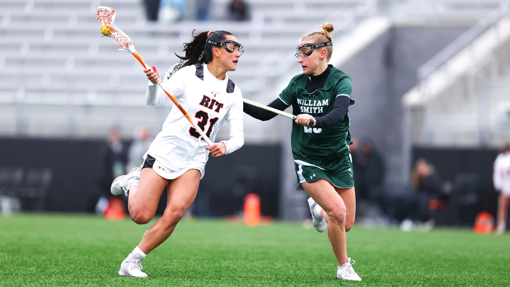 Kate Trojan cradles past a William Smith defender