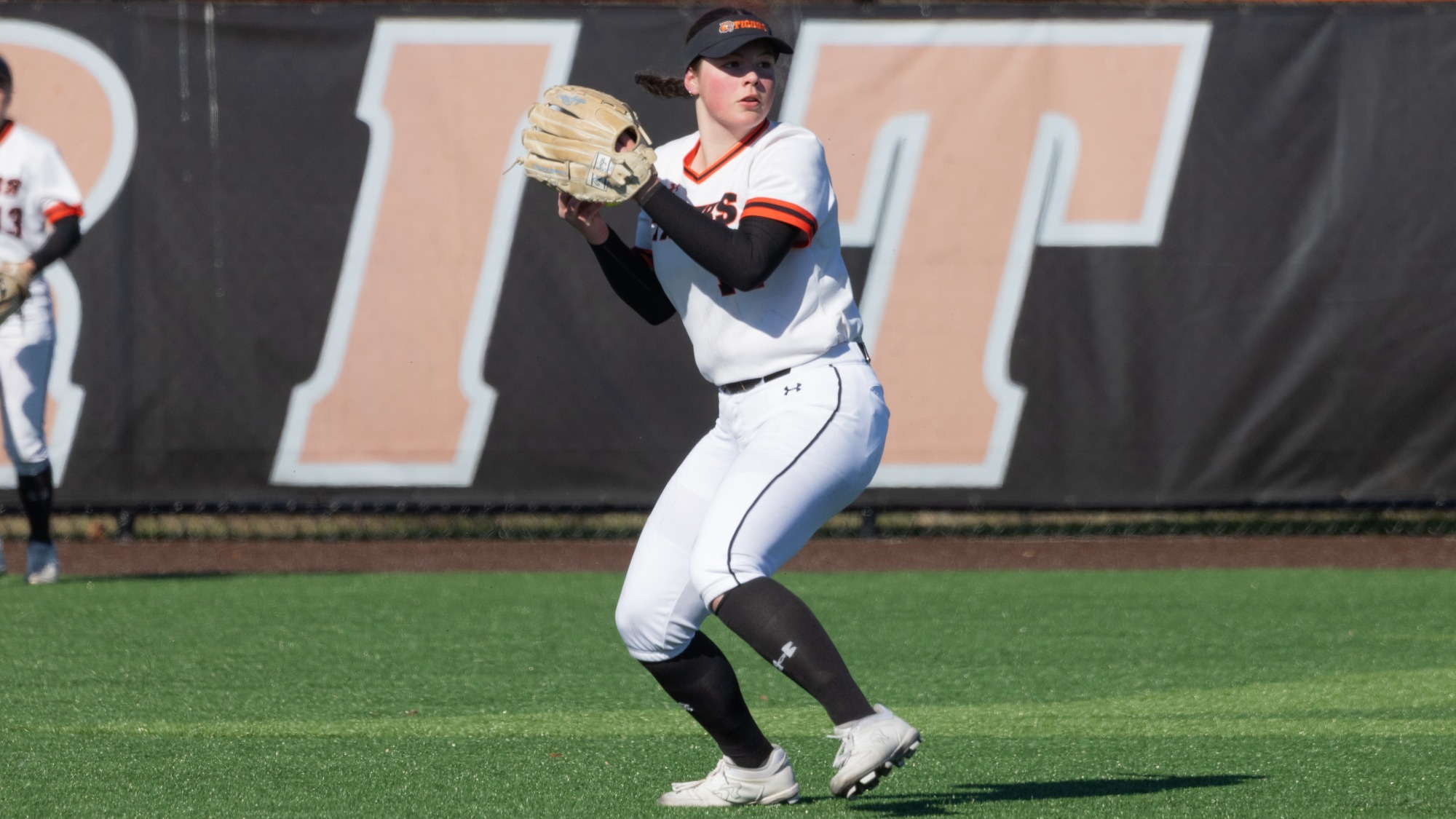 a softball outfielder getting ready to throw a ball into the infield