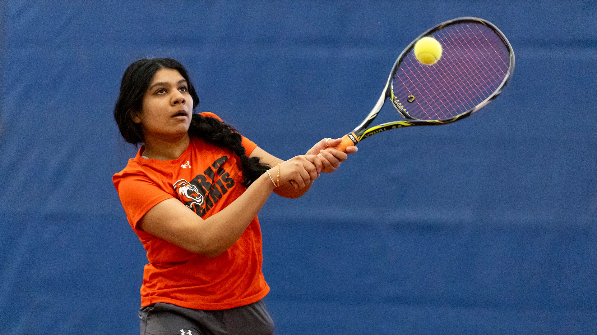 A women's tennis player hitting a forehand against Hamilton
