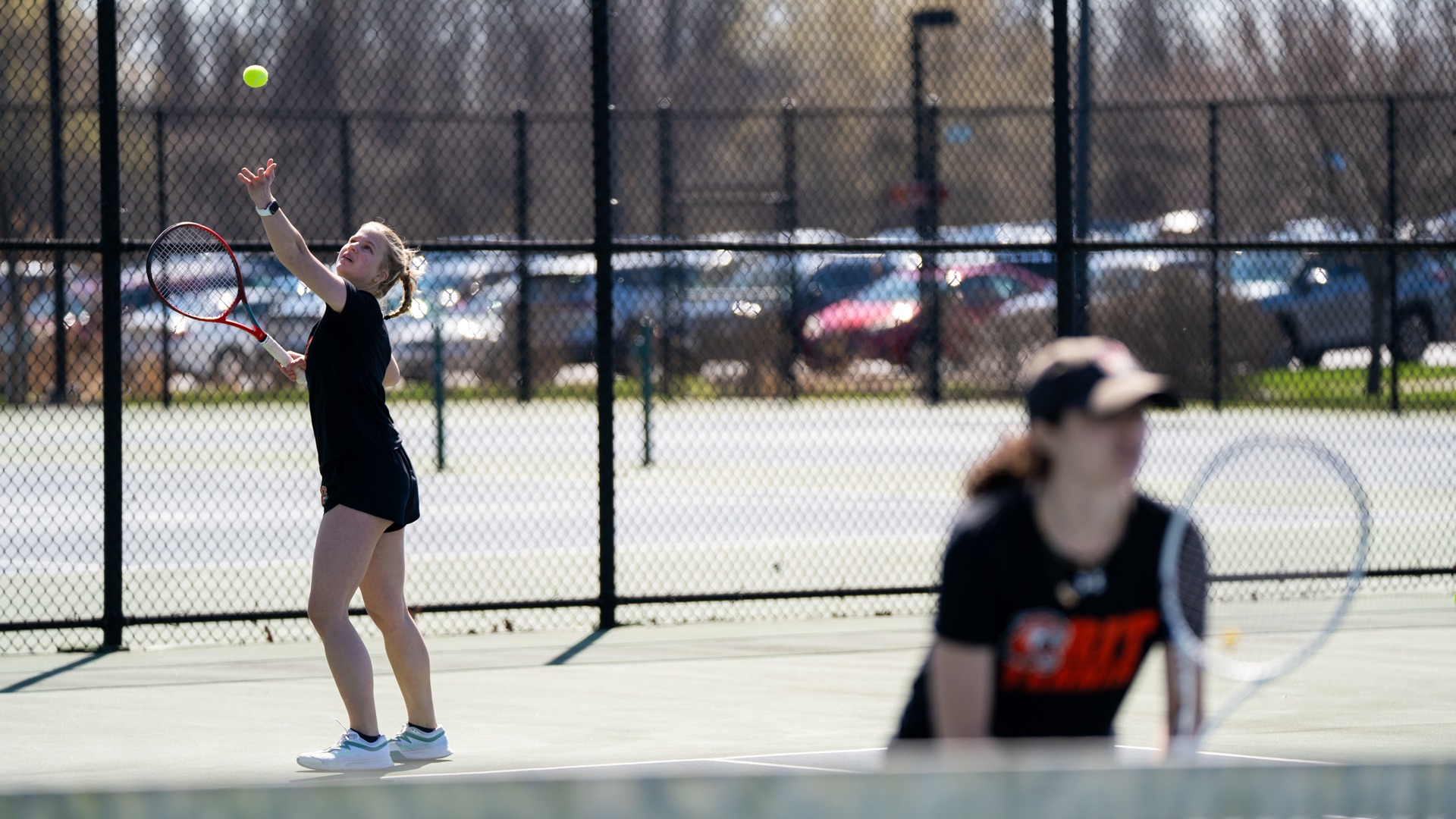 Emily Greb serves a ball in her doubles match against William Smith