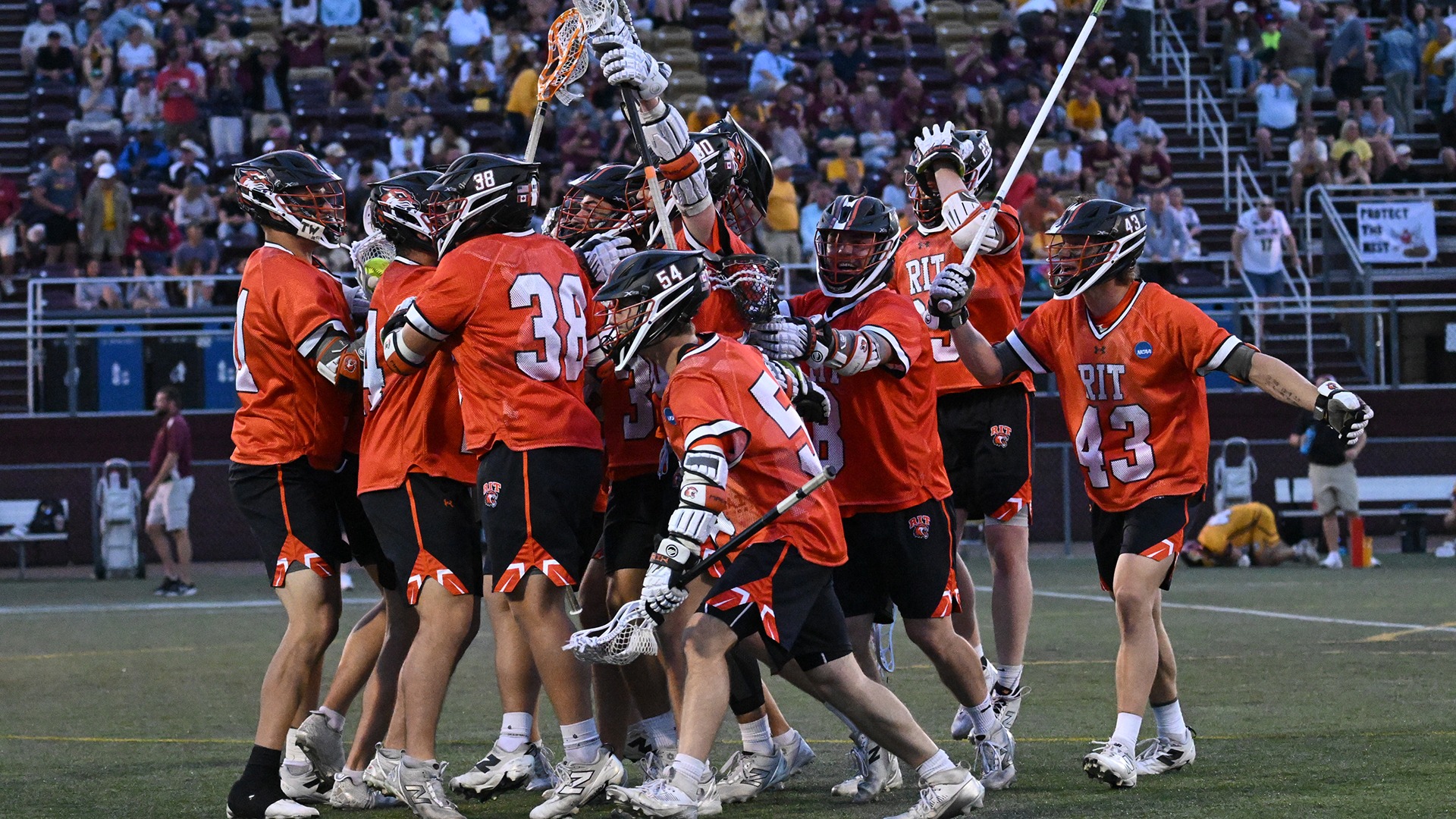 A photo of the men's lacrosse celebrating after defeating Salisbury in OT