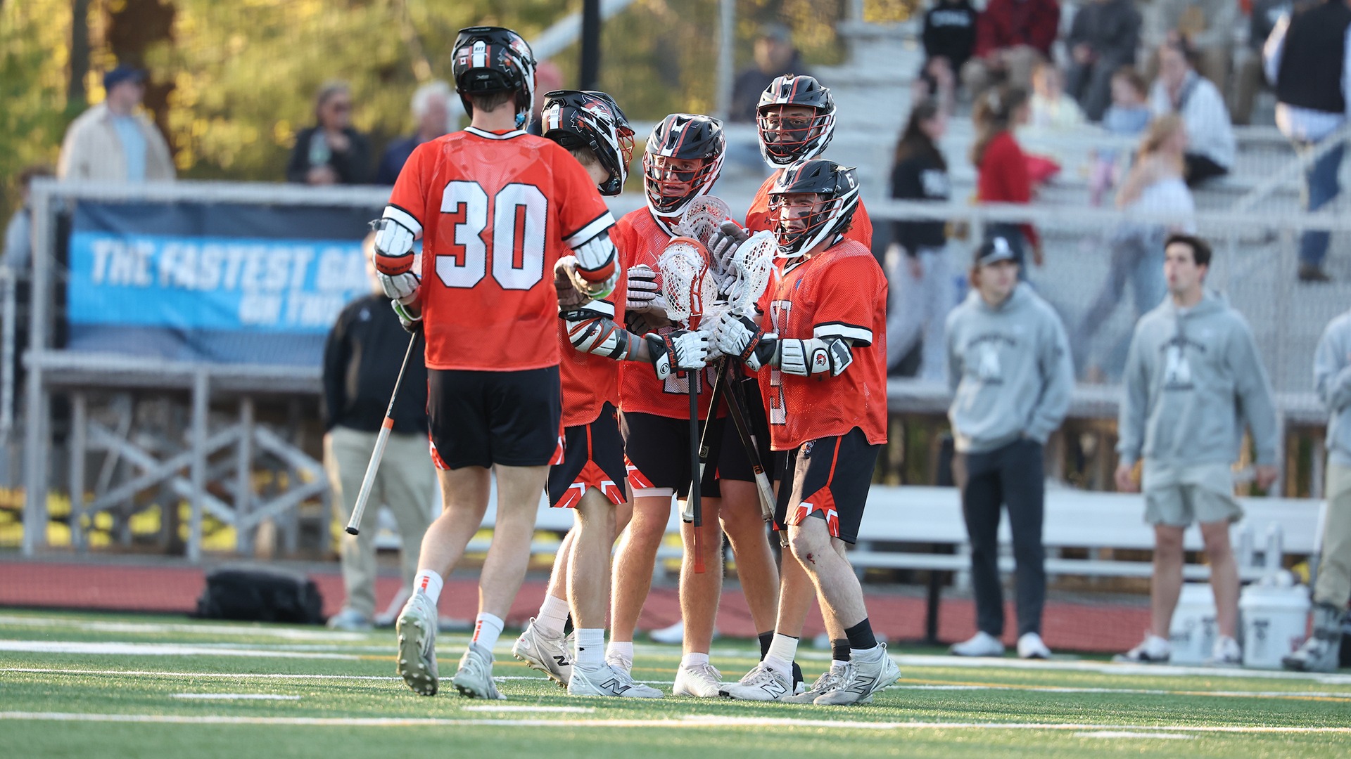 RIT men's lacrosse players celebrating a goal against Bowdoin in NCAA Semifinal