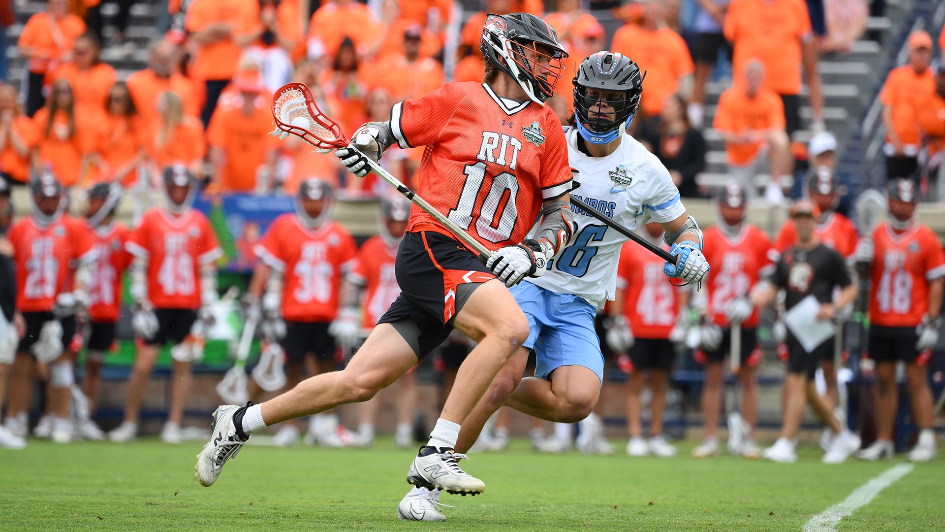 RIT's David Charney sprinting past a Tufts defender at the 2026 NCAA Championship