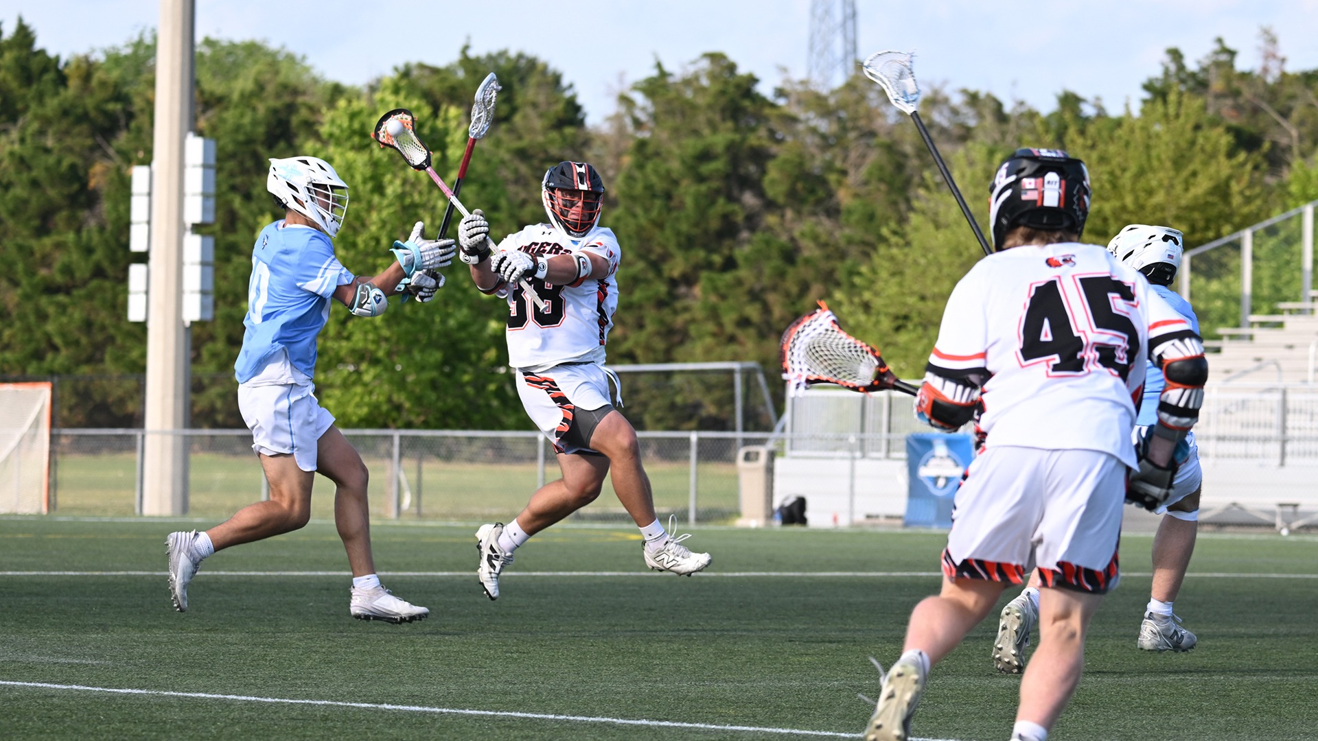 Philip Minardo carries the ball after winning a face-off against Elmhurst