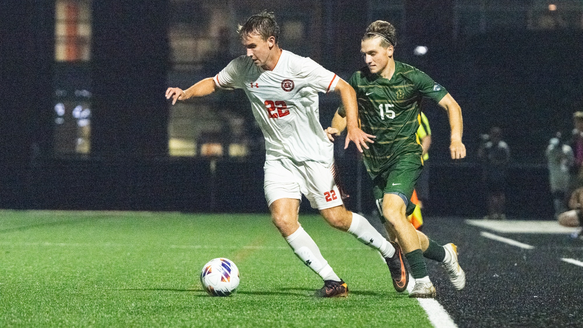 A photo of Gavin Culley dribbling a soccer ball past a defender