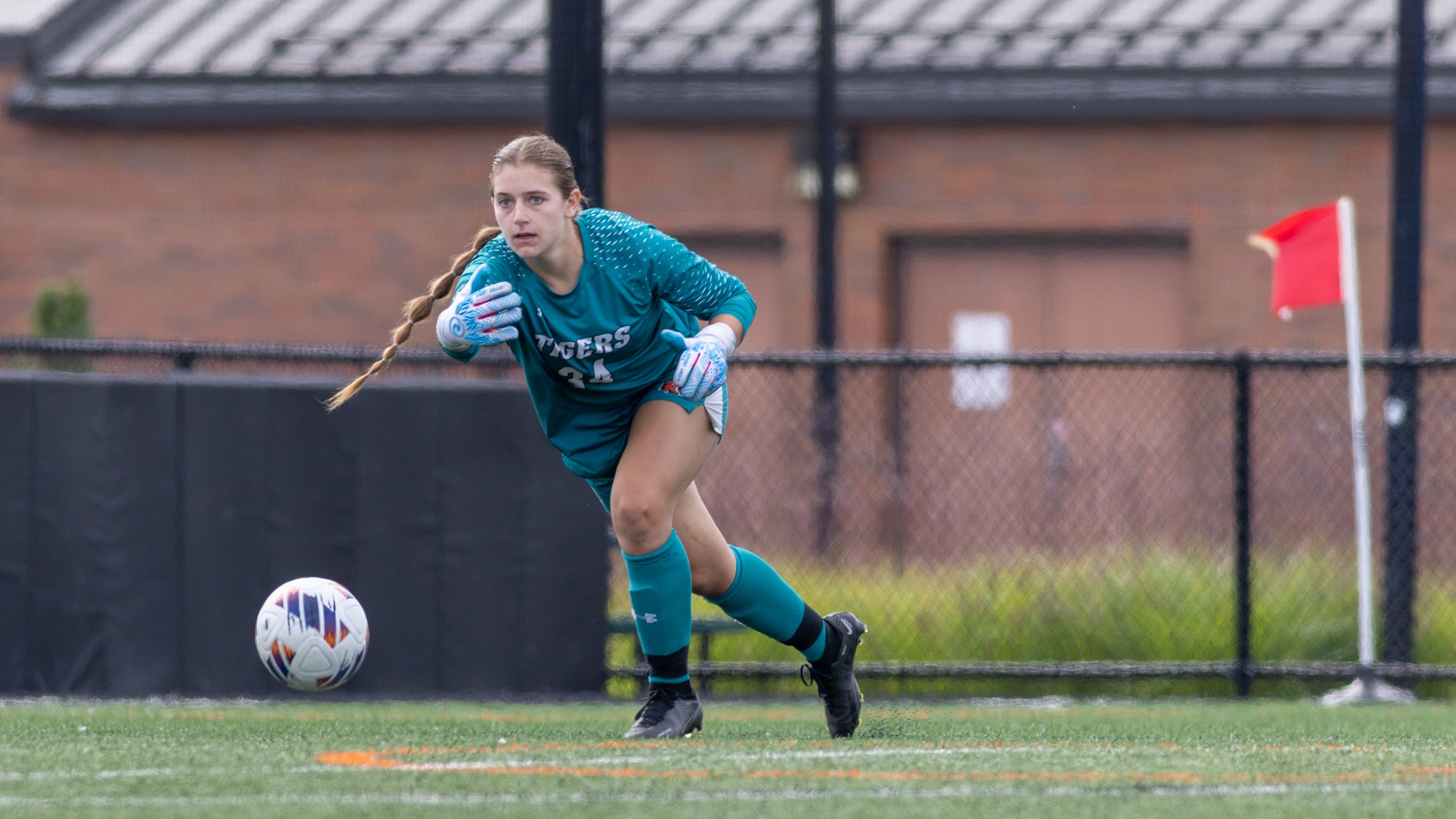 RIT's Ashton Anderson, #34, passing the ball to a defender on Saturday, Sept. 26, 2026, at Thomas Fearey Judson Jr. Stadium. RIT Athletics / Grace Taberski.