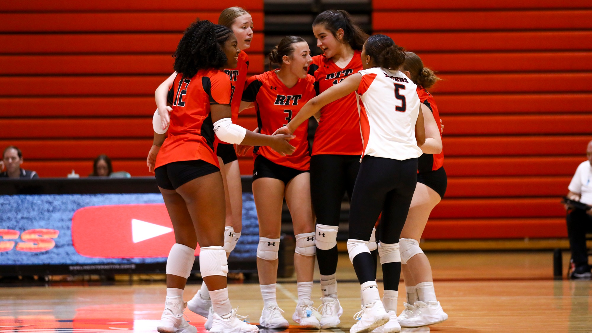 a huddle of women's volleyball players