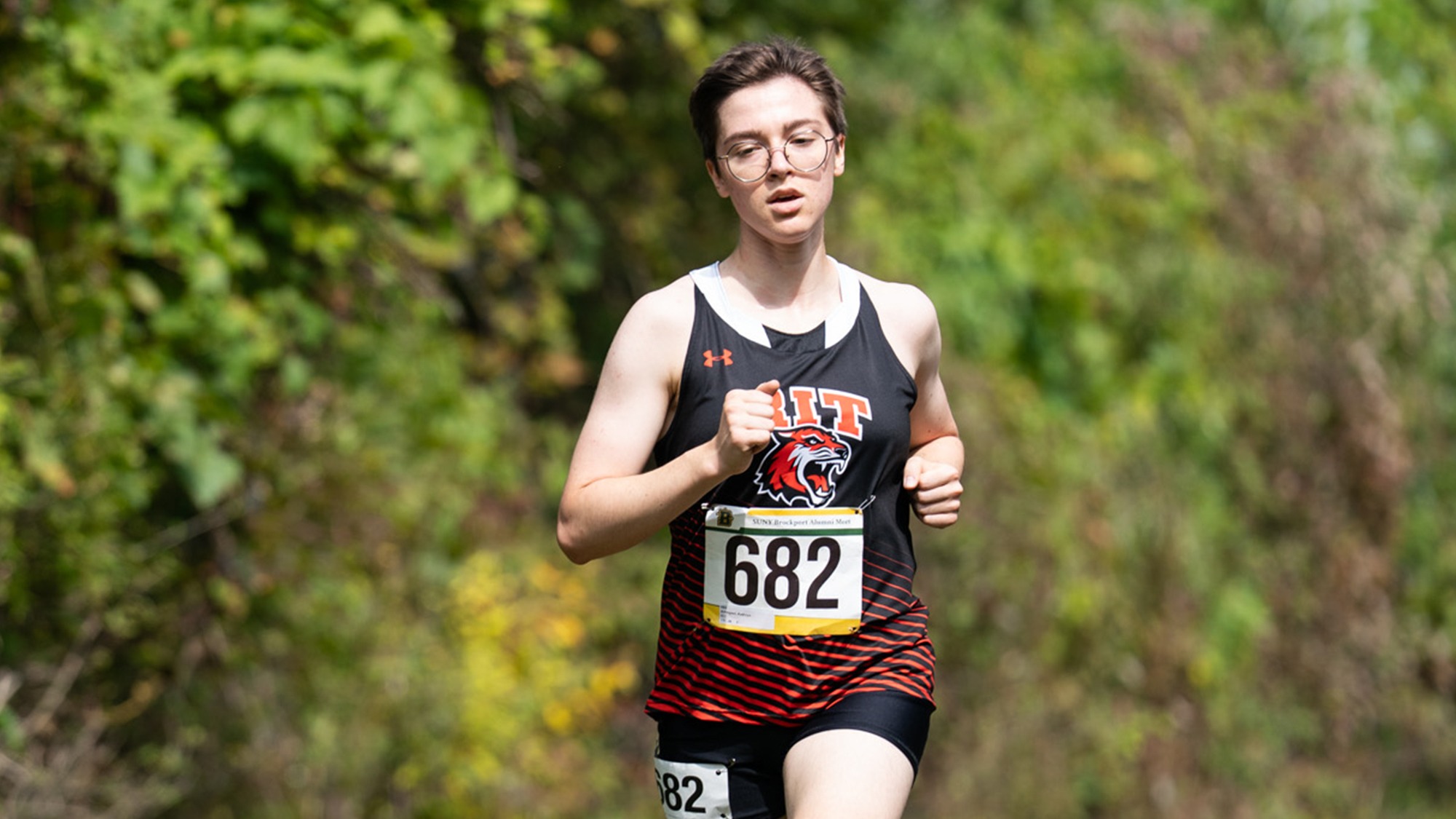 Running through the woods RIT’s Kathryn Arbegast races on September 6, 2025, at Sweden Town Park in Brockport, New York. RIT Women’s Cross Country finished 2nd at the Tom Balon Alumni Classic hosted by SUNY Brockport. (Colin Norland/RIT Sports Network).