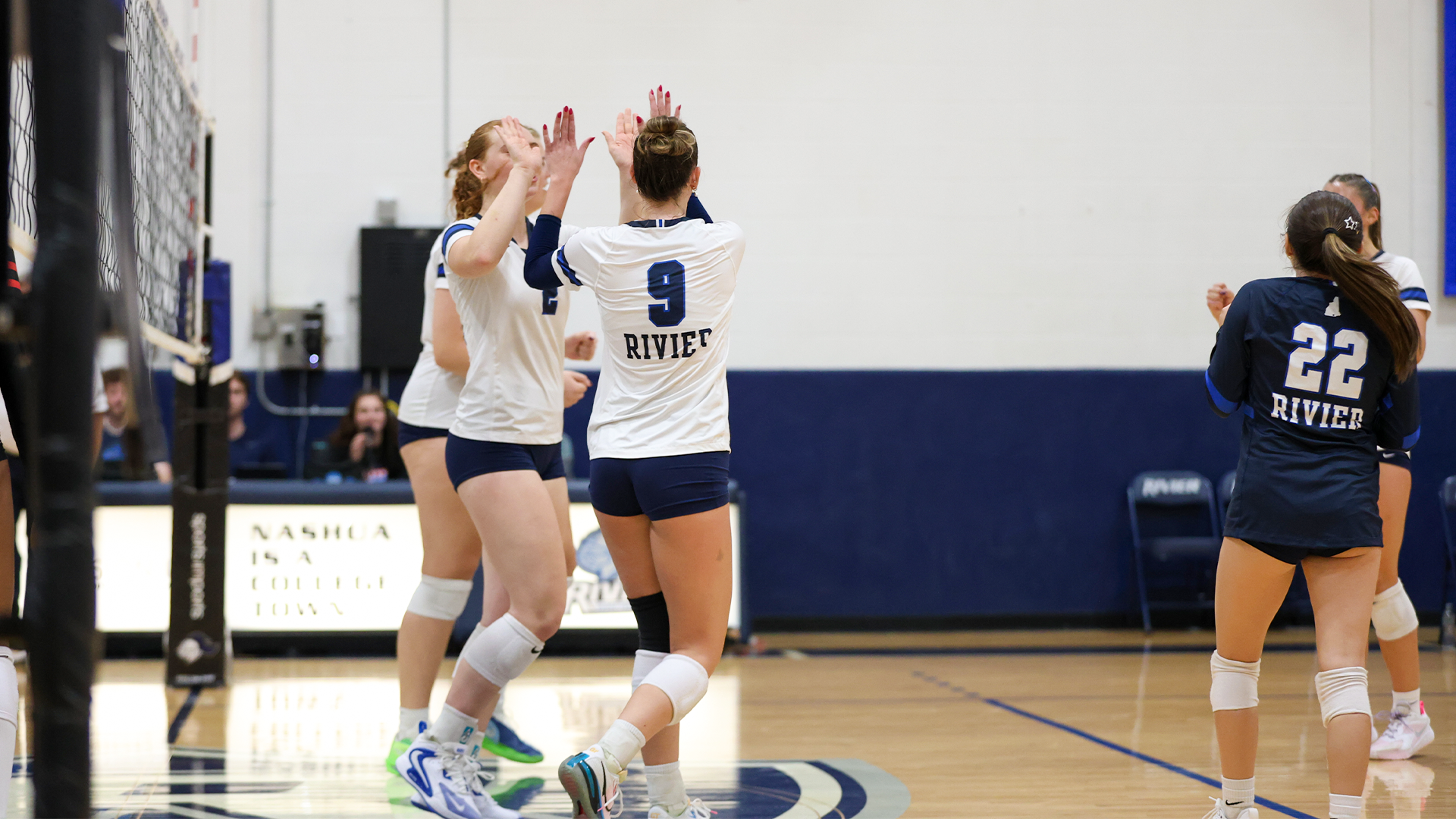 Ava Pohopek and Sam Driend high fiving