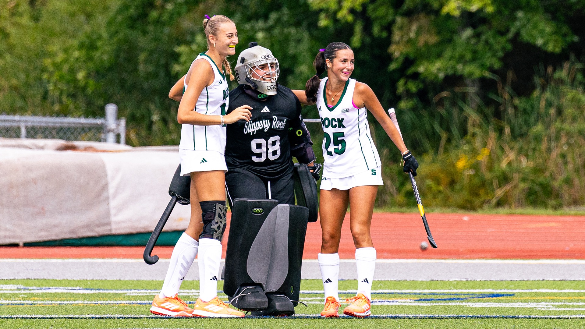 A photo of Slippery Rock Field Hockey celebrating its win vs. Lander