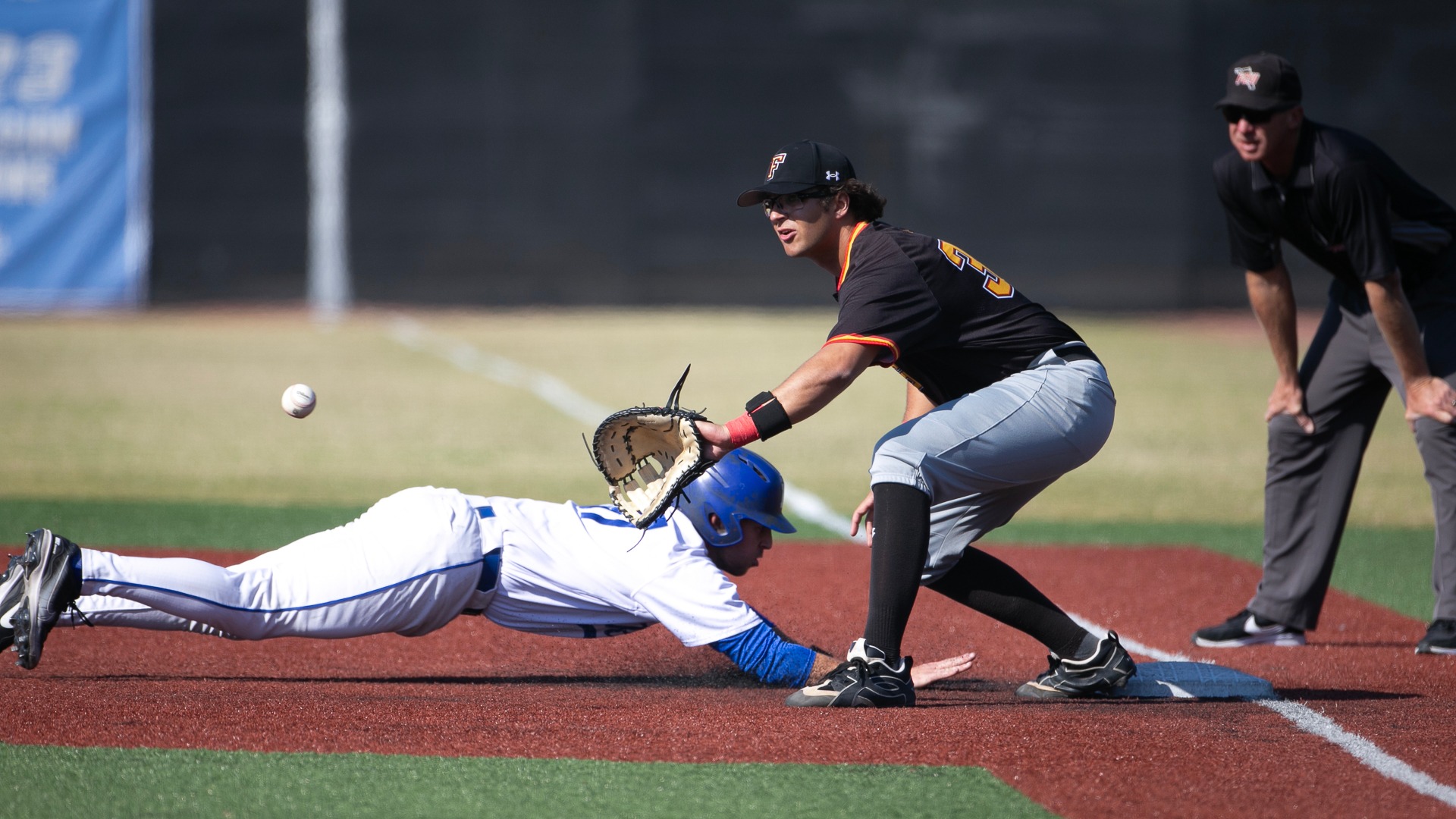 BASE Deans diving back to first base