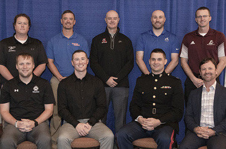 Jason Jackson seated at the 2023 American Baseball Coaches Association/Marines Assistant Coach of the Year for Division I induction