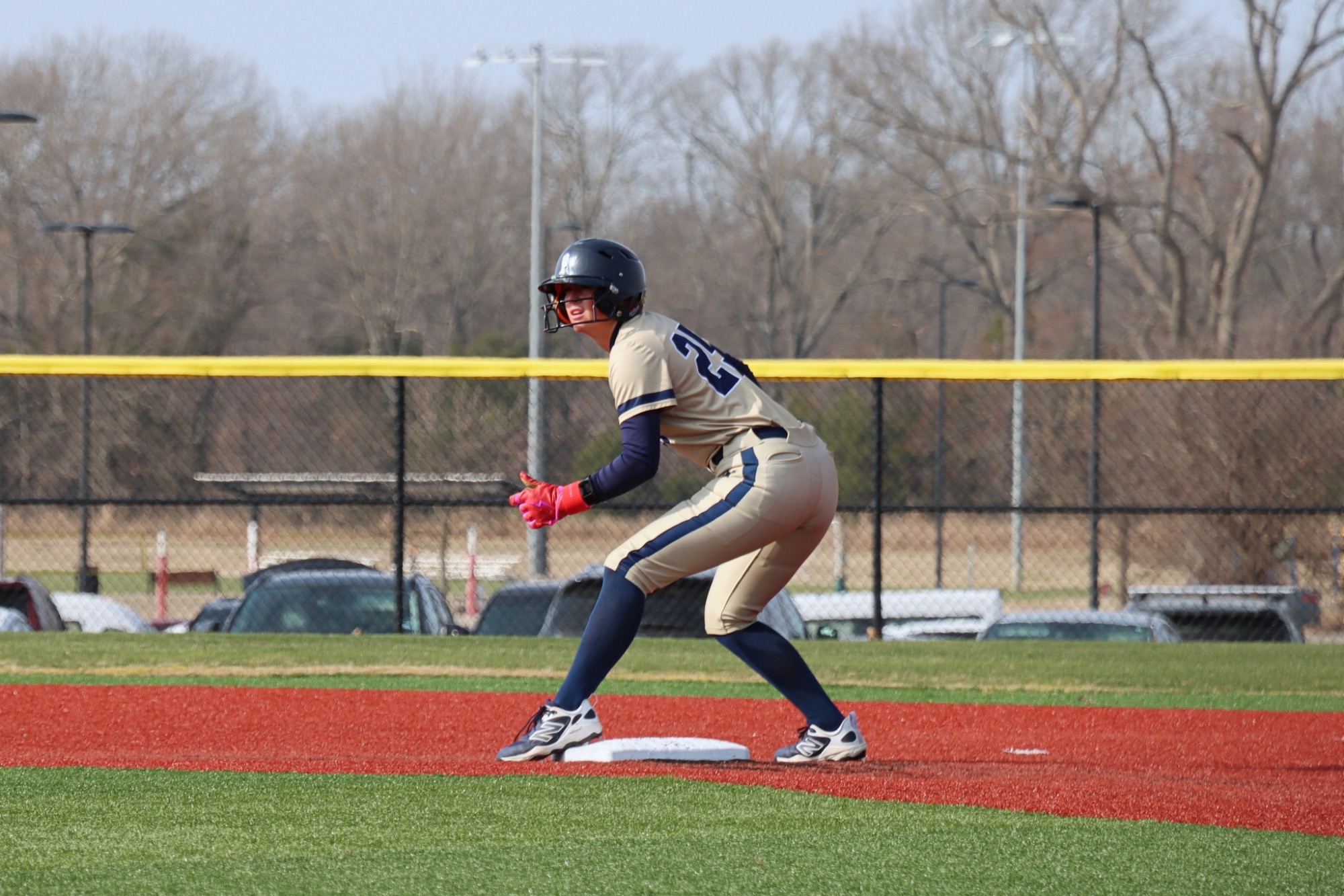 Number 25 on softball team on base ready to run