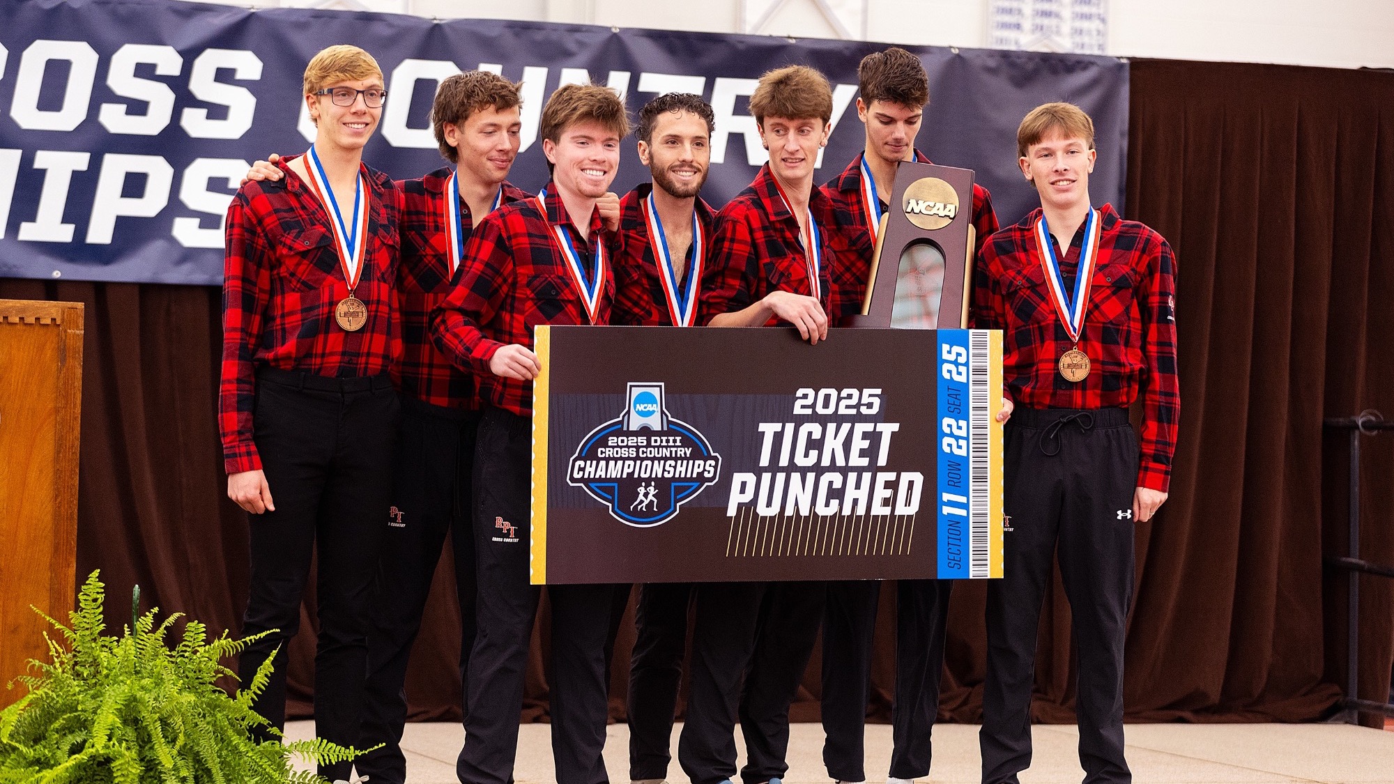 The RPI men’s cross country team celebrating on the podium after winning the 2025 NCAA Northeast Regional Championship on Saturday, November 15, 2025 in Canton, New York