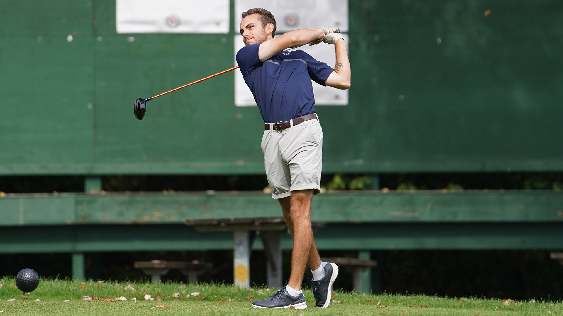 A TMU golfer holds his follow through after teeing off.