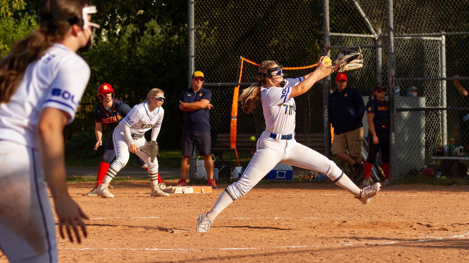 A TMU pitcher is in her windup to deliver a pitch.