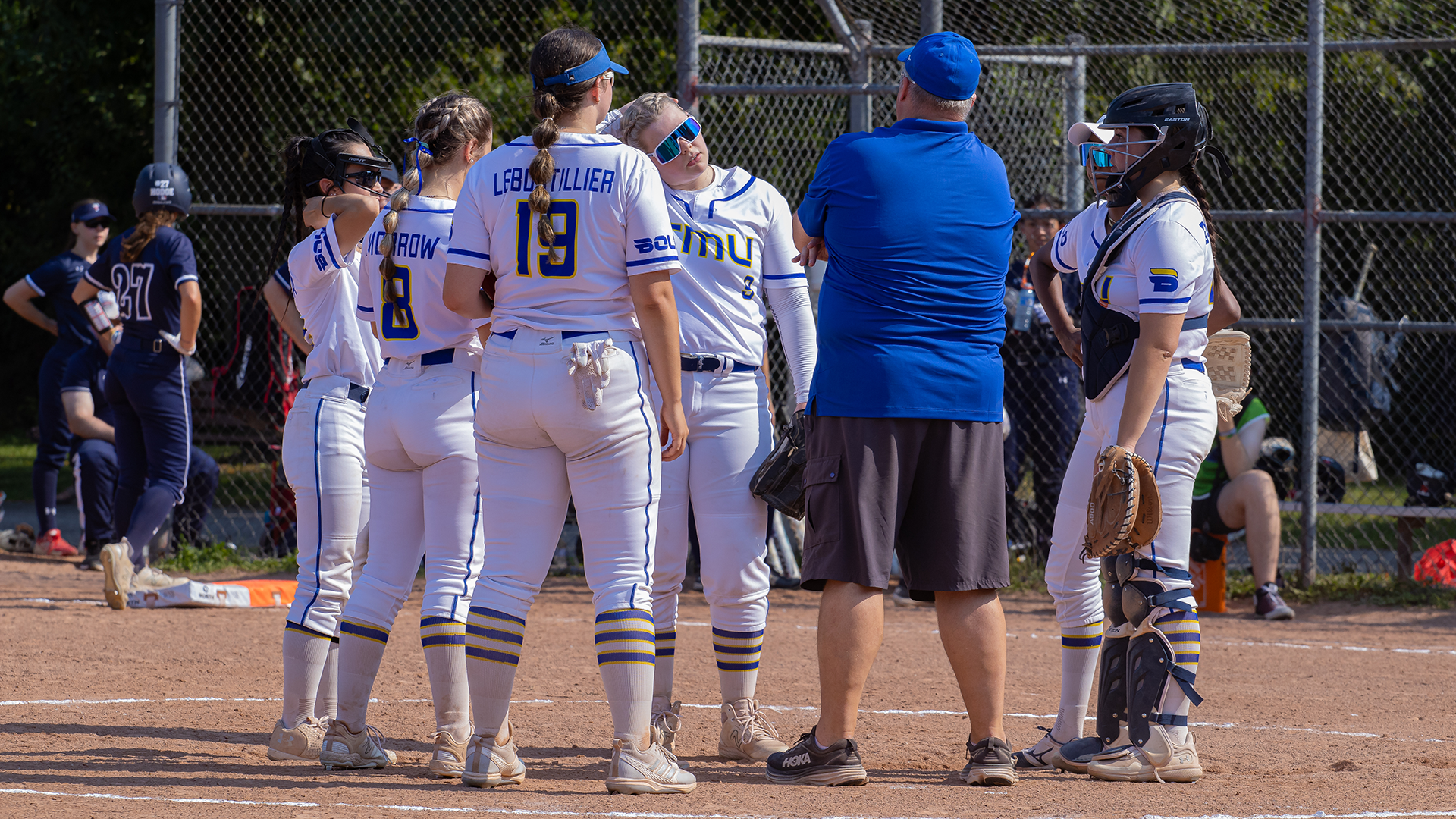 TMU Softball Players Strategize While Standing On The Mound