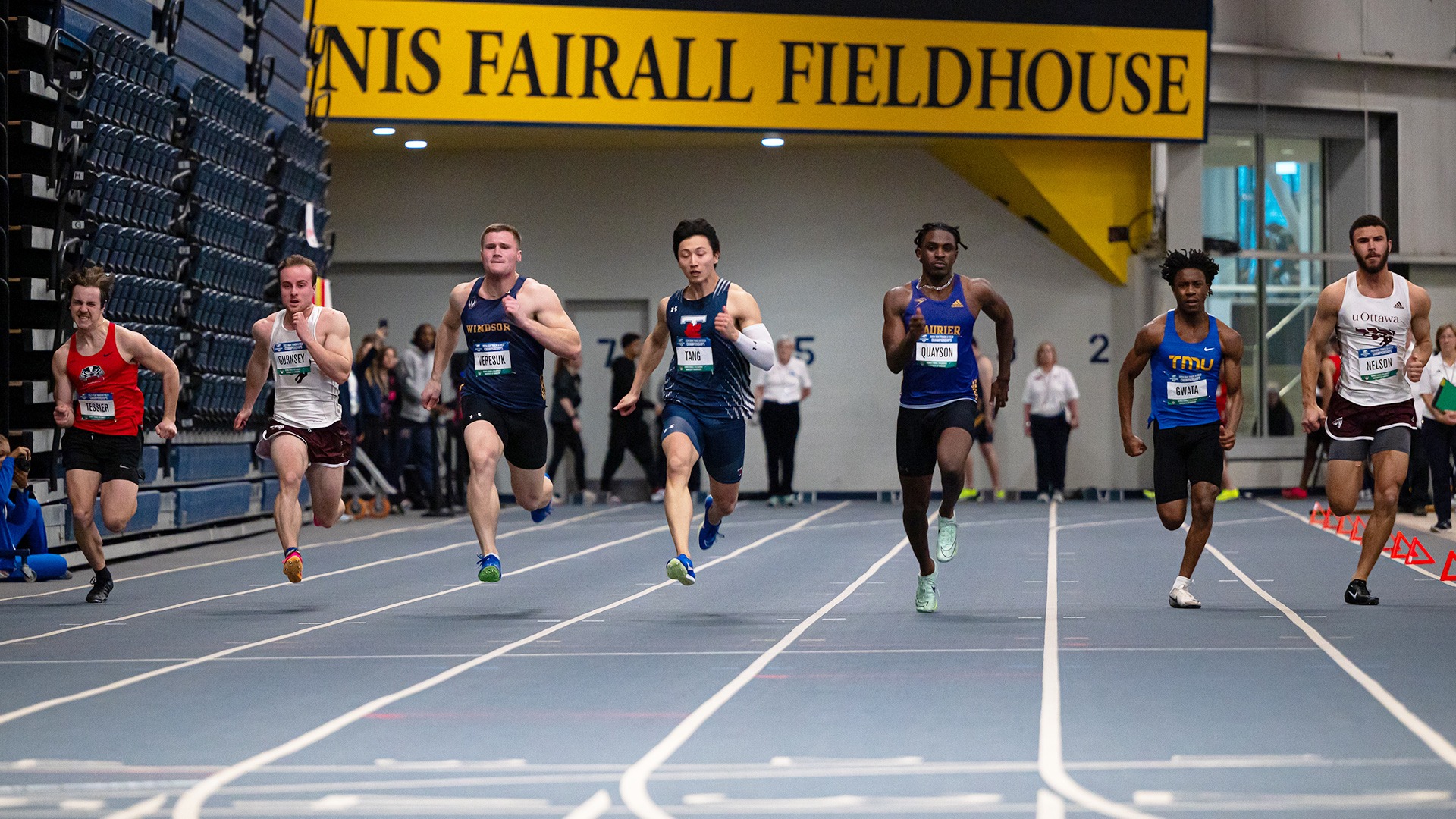 Seven athletes sprint down the track