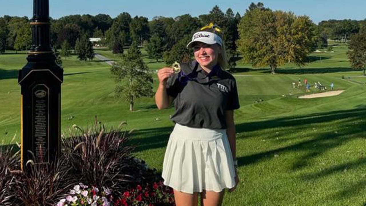 Abigail Dove smiles with medal after clinching win at Western Invitational 