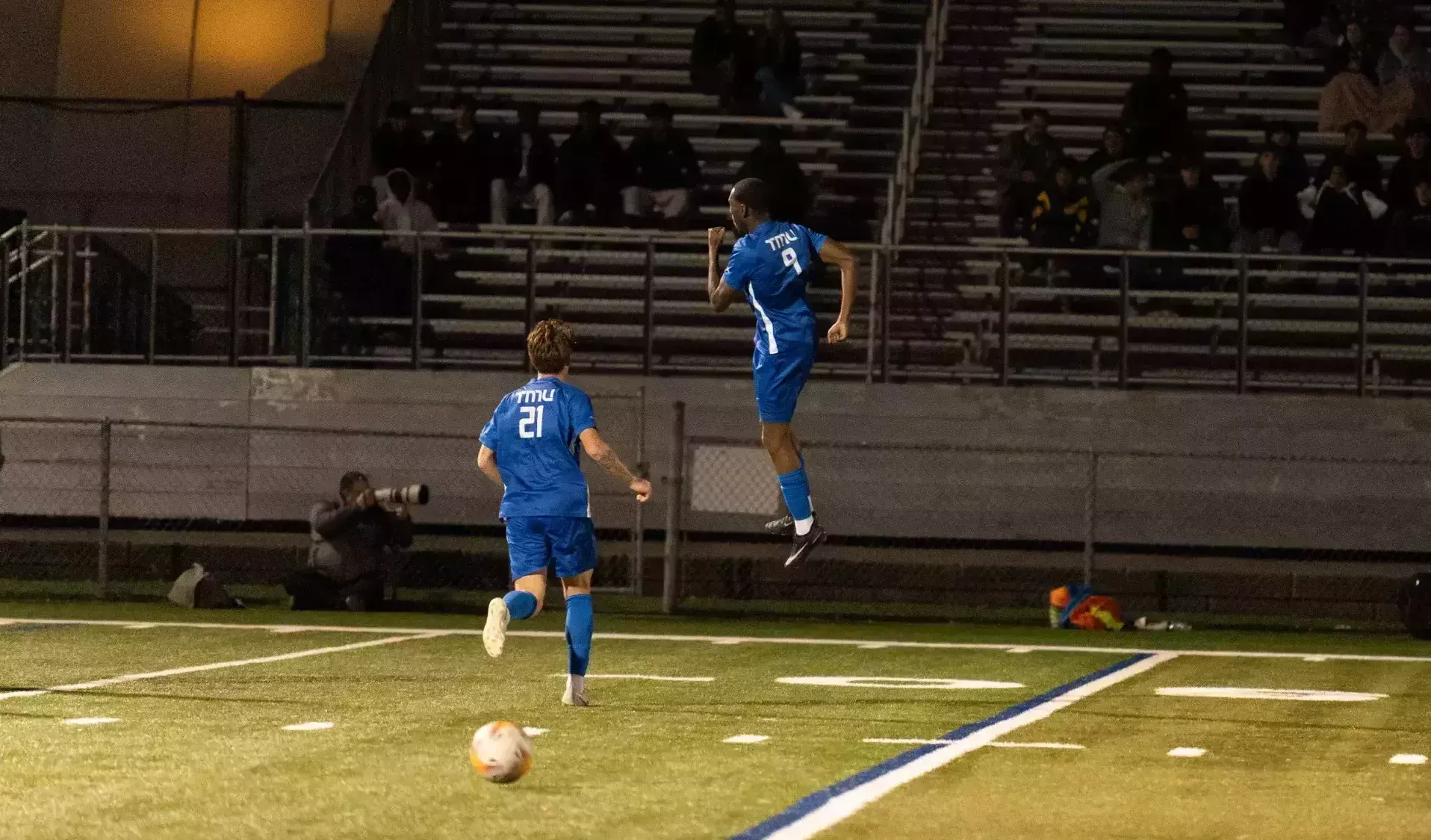 TMU Bold and Cyrus Rollocks celebrating their goal on the pitch against Carleton