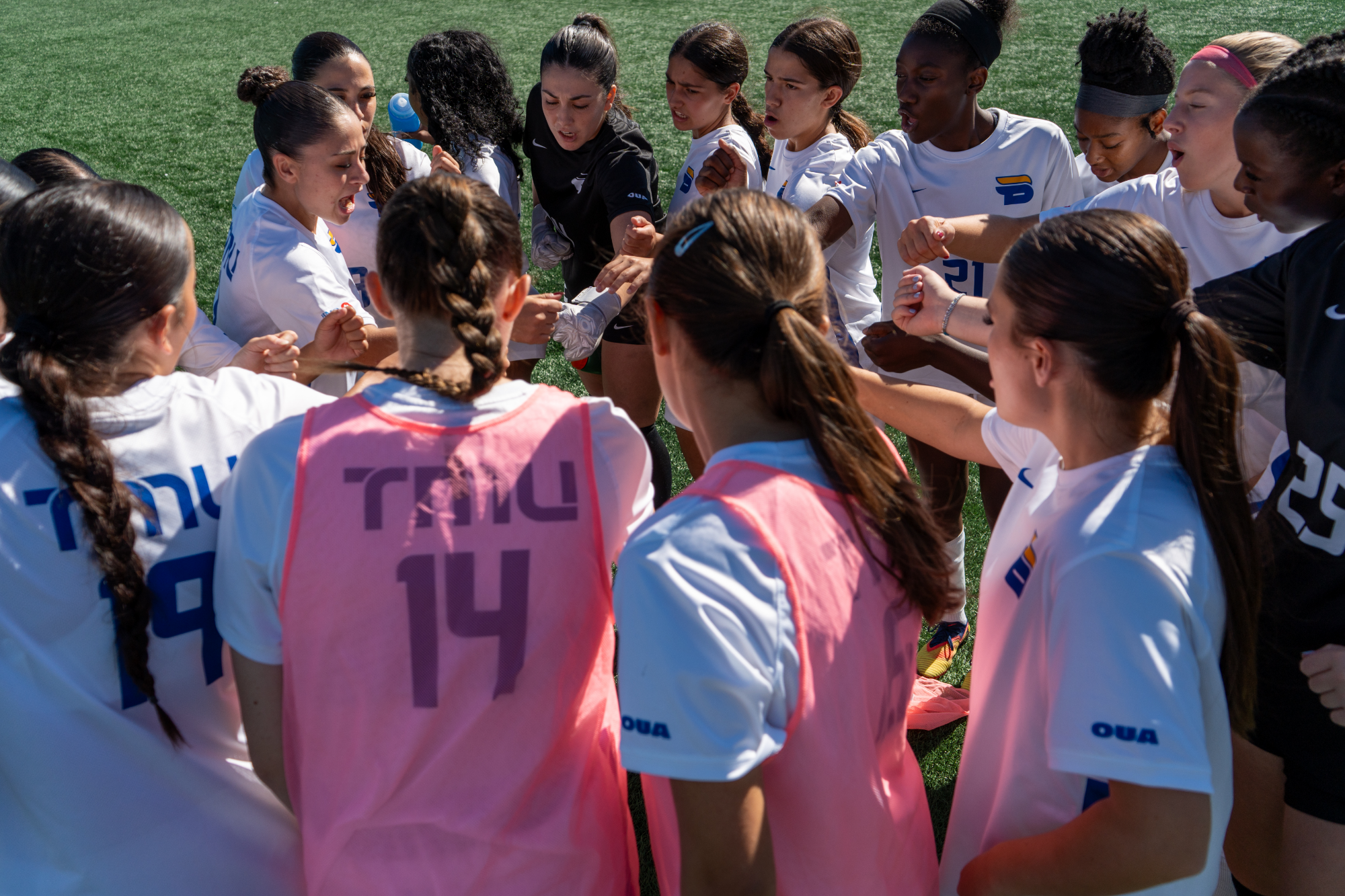 TMU Bold Women's Soccer Team huddle for a cheer