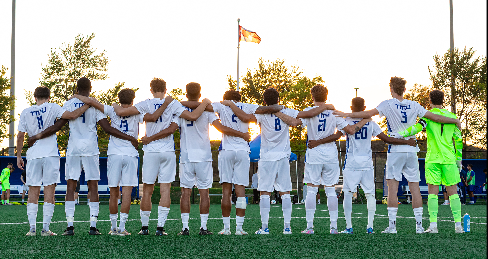 The Toronto Metropolitan University (TMU) Bold men's soccer team stand during the Canadian national anthem.