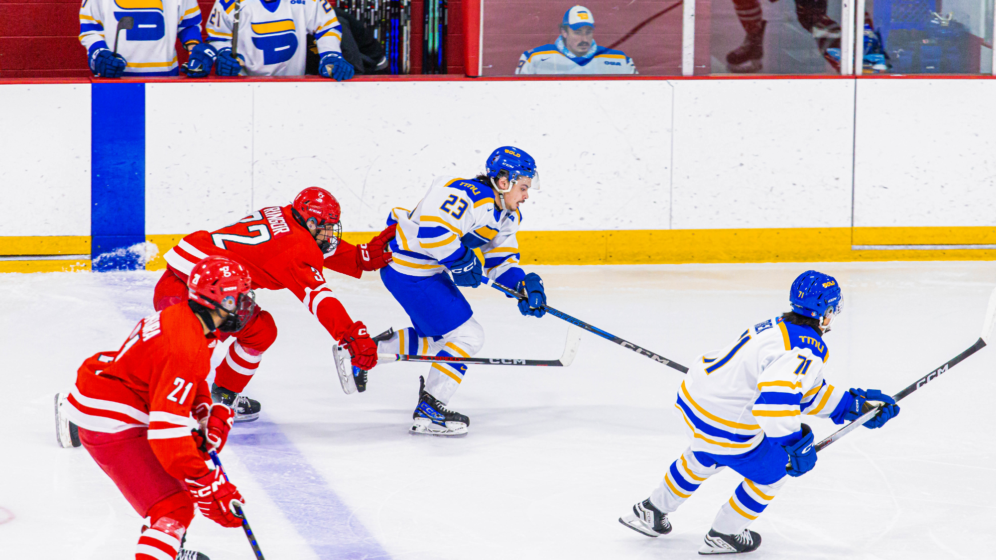 Spencer Shugrue skates with the puck against York