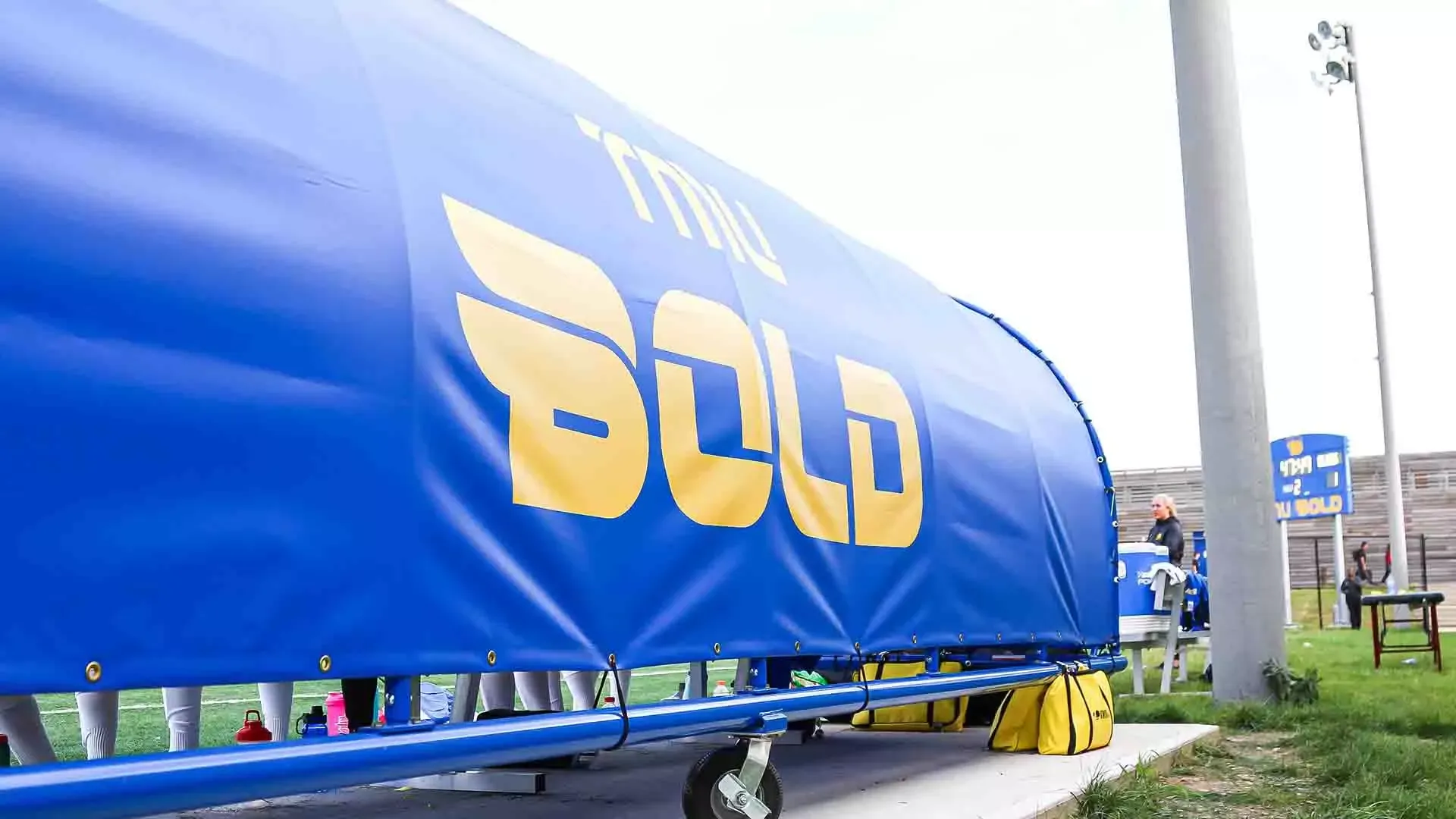 Covered player bench at Downsview Park branded with Bold B logo