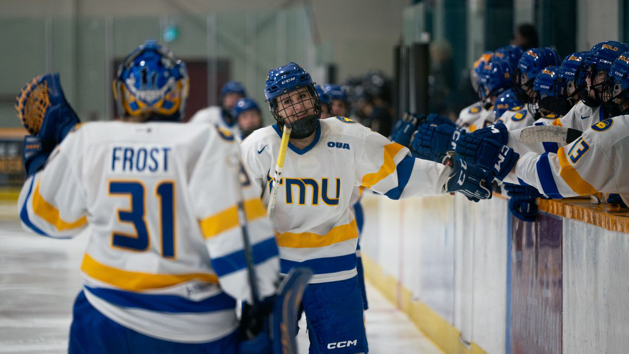 Katie Frost celebrates with her teammates after a goal