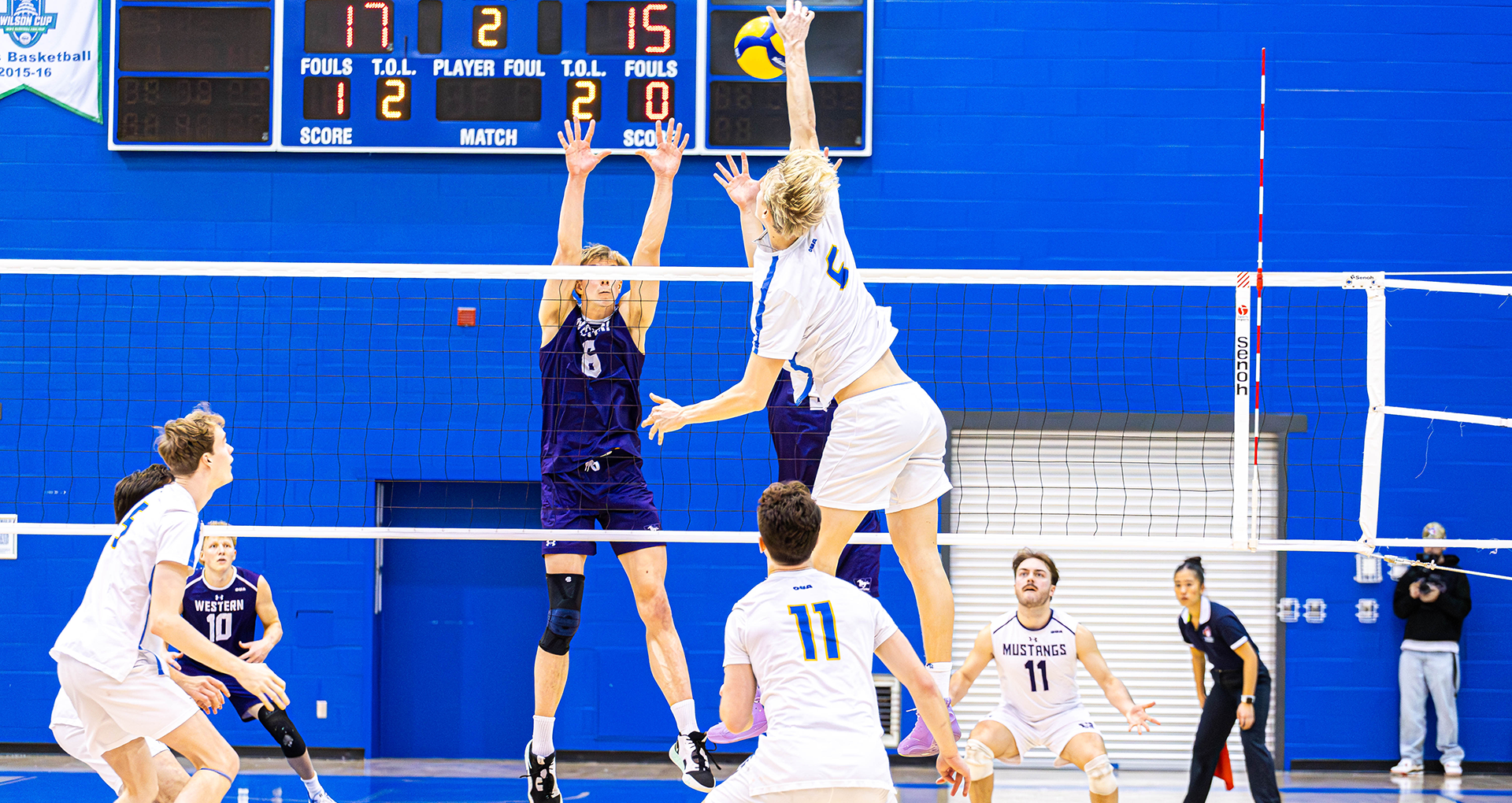 TMU Bold men's volleyball player Ross Buchanan spikes ball against Western Mustangs