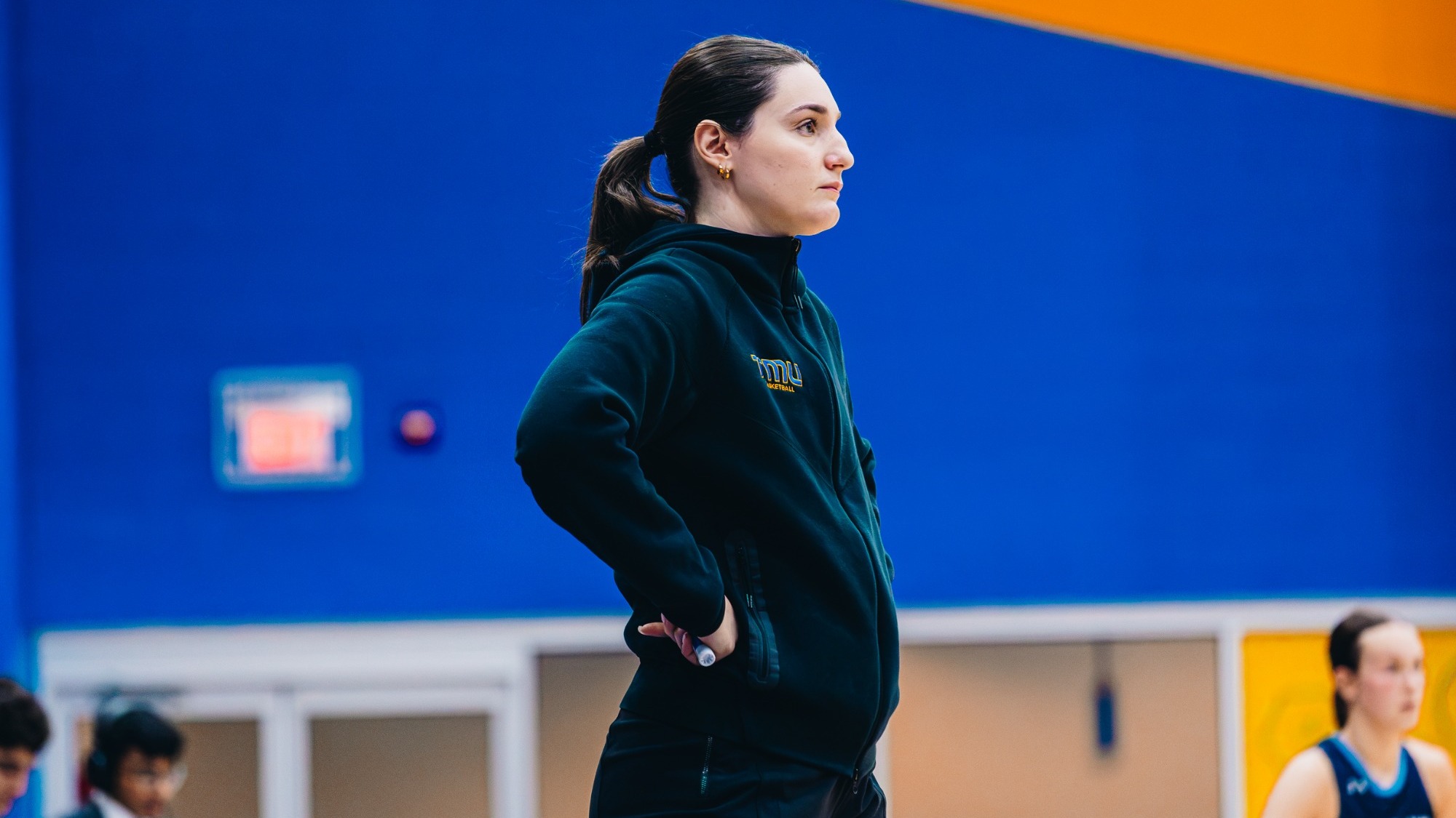 Bold interim head coach Stefanija Mrvaljevic looks onto the court in a pre-season matchup