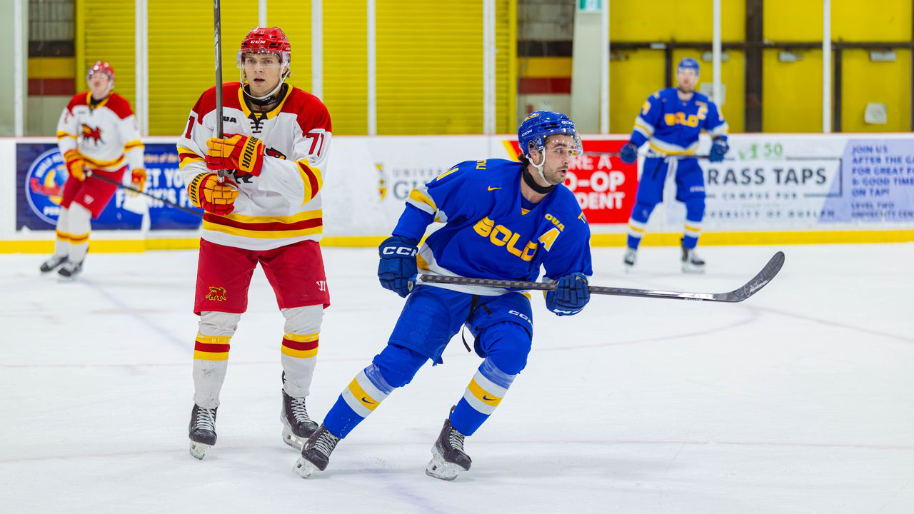 Gavin Grundner skating past a Gryphon