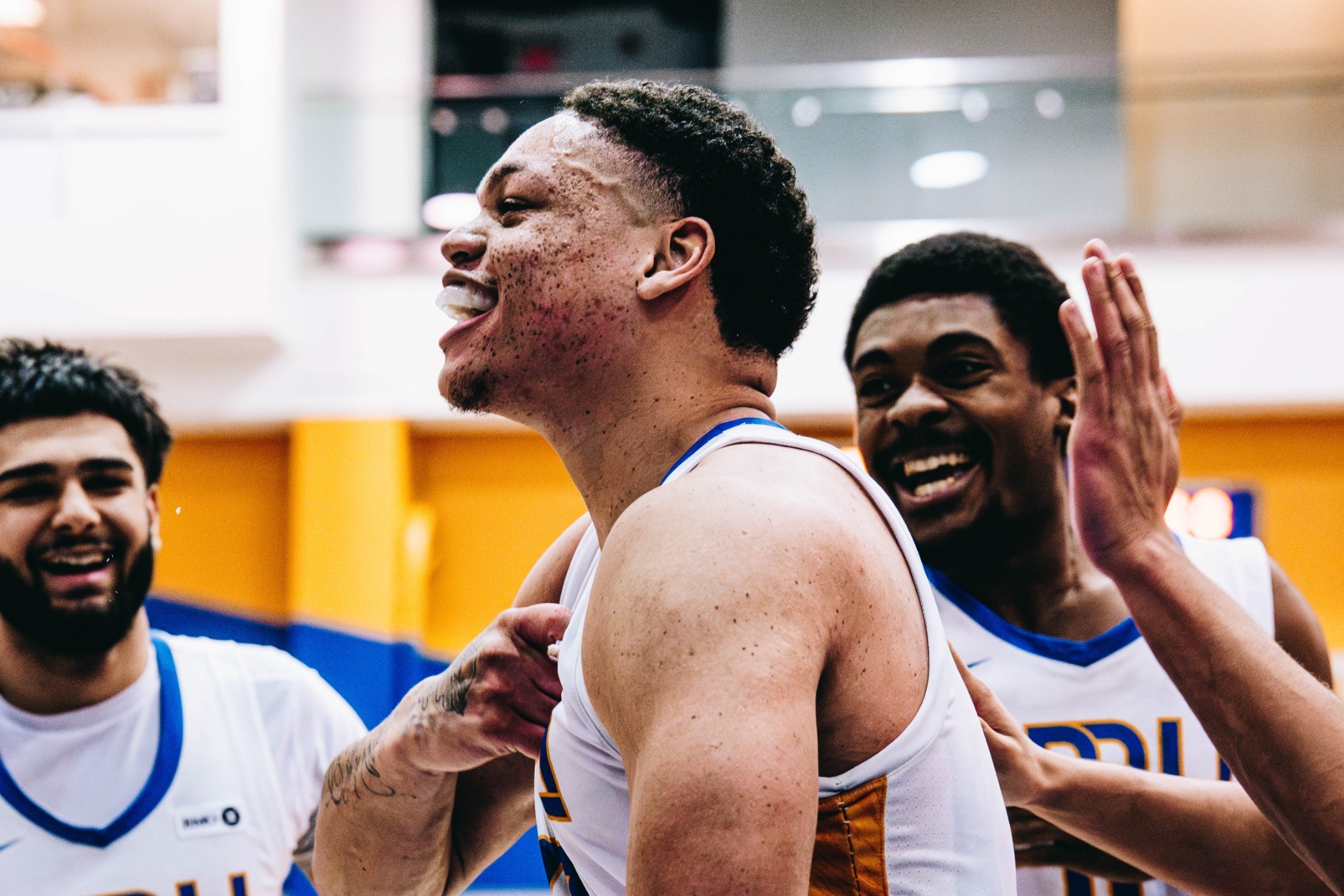 Rhooms getting hype with his teammates cheering him on